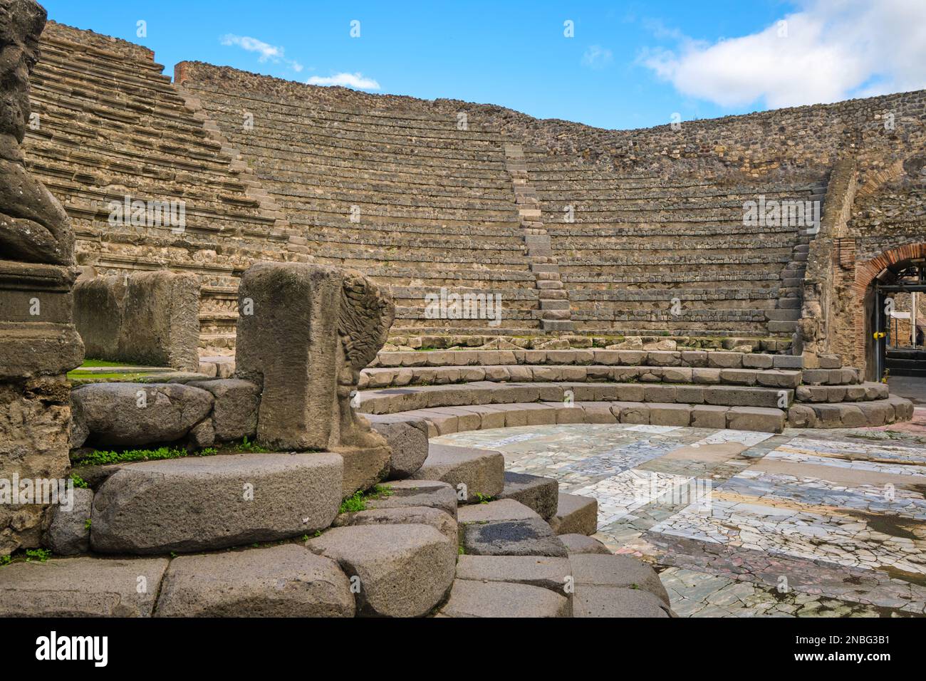 A view of the stone seating at the cute, little, small Teatro Piccolo Odeon theater. At Pompeii Archaeological Park near Naples, Italy. Stock Photo