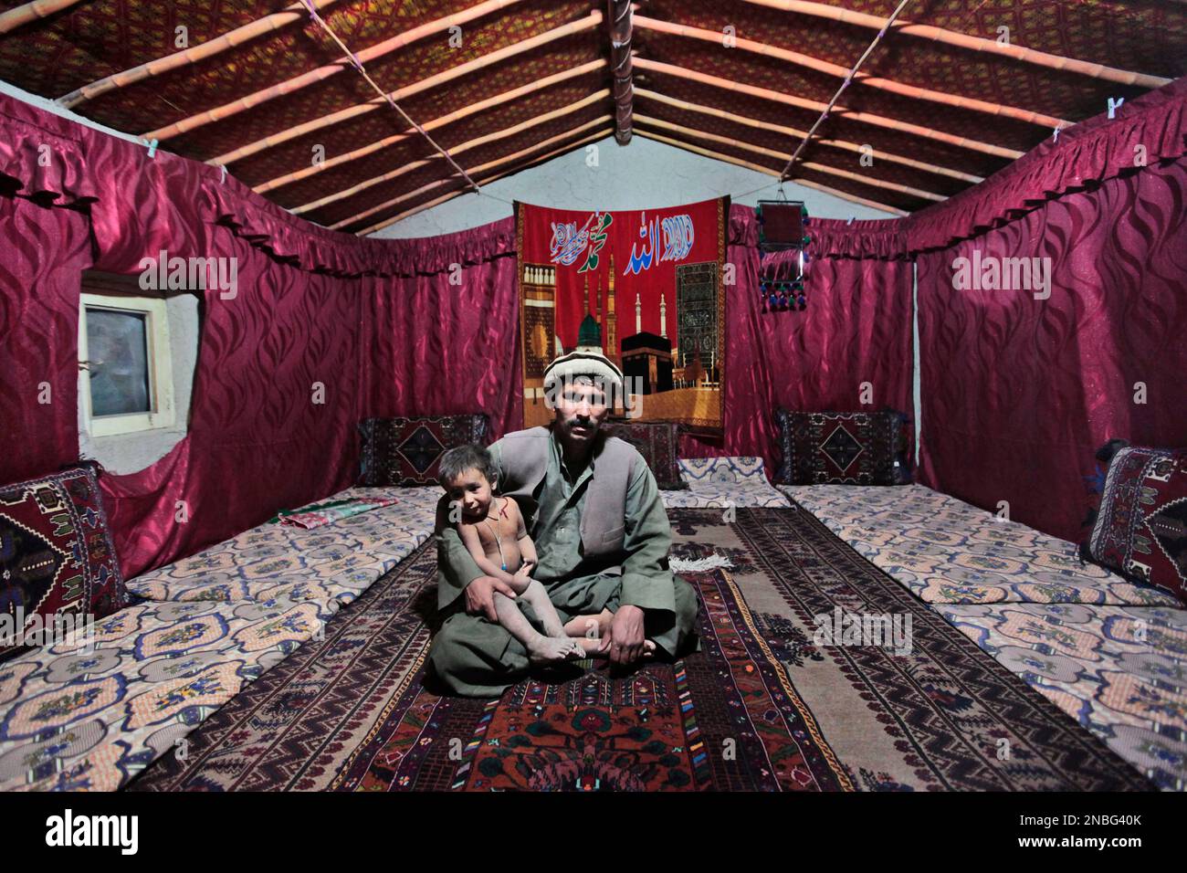 Afghan Ahmed Rind Soharab Ahmed, an Afghan man holds his son Ameer Ahmed as they poses ...