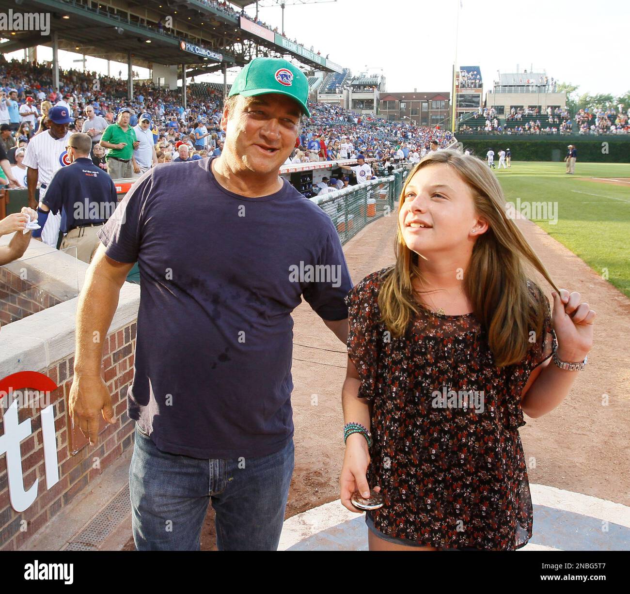 Actor Jim Belushi congratulates his daughter Jamison after she sang the national anthem before a baseball game between the Chicago Cubs and the Philadelphia Phillies Monday, July 18, 2011 in Chicago. (AP Photo/Charles Rex Arbogast) Stock Photo