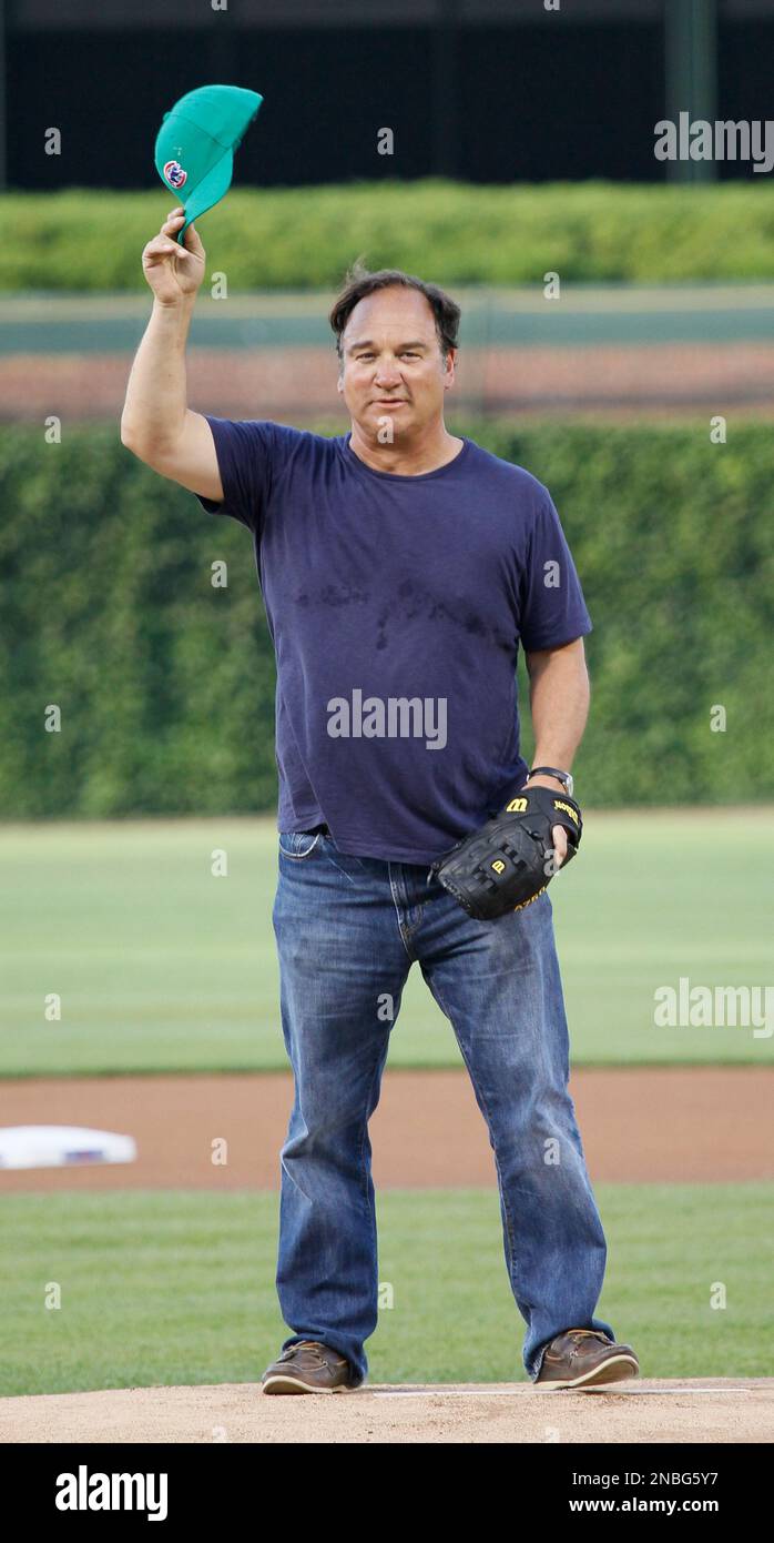 Actor Jim Belushi salutes the crowd before throwing out a ceremonial first pitch at baseball game between the Chicago Cubs and the Philadelphia Phillies Monday, July 18, 2011 in Chicago. (AP Photo/Charles Rex Arbogast) Stock Photo