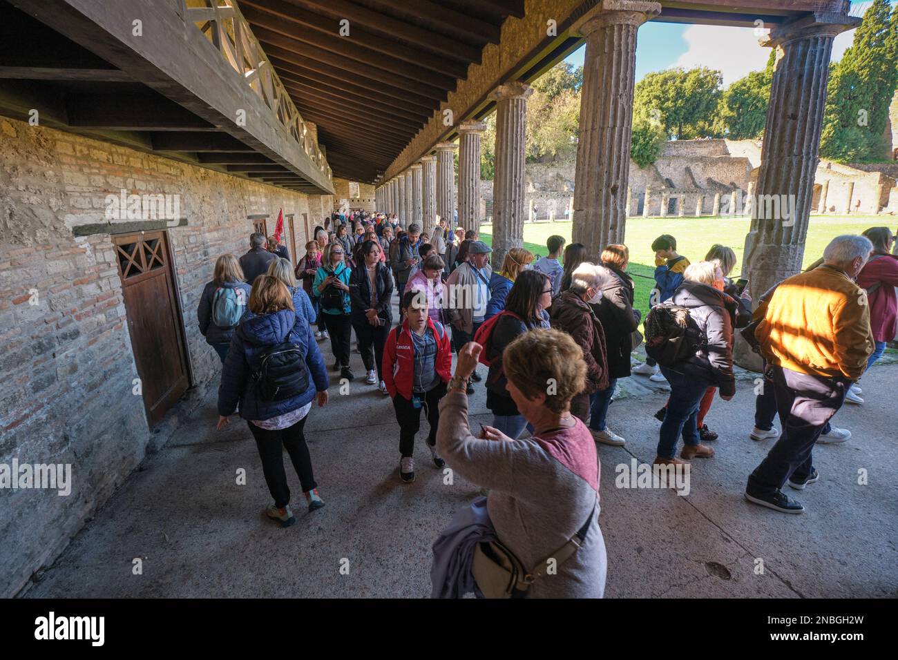Groups of tourists, visitors pack, crowd the Quadriportico dei Teatri
