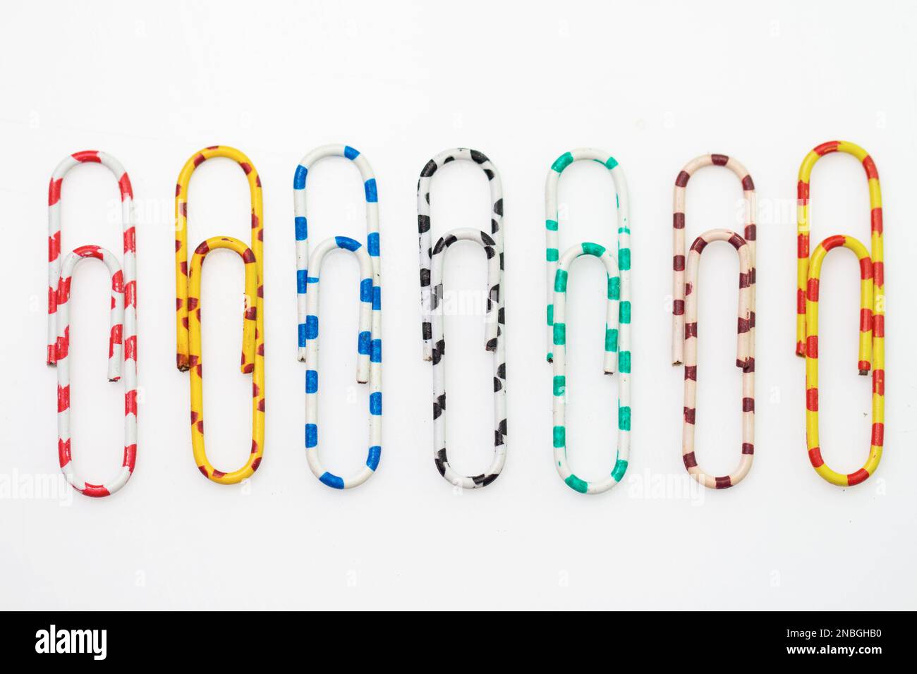 different colored paper clips isolated on white background Stock Photo