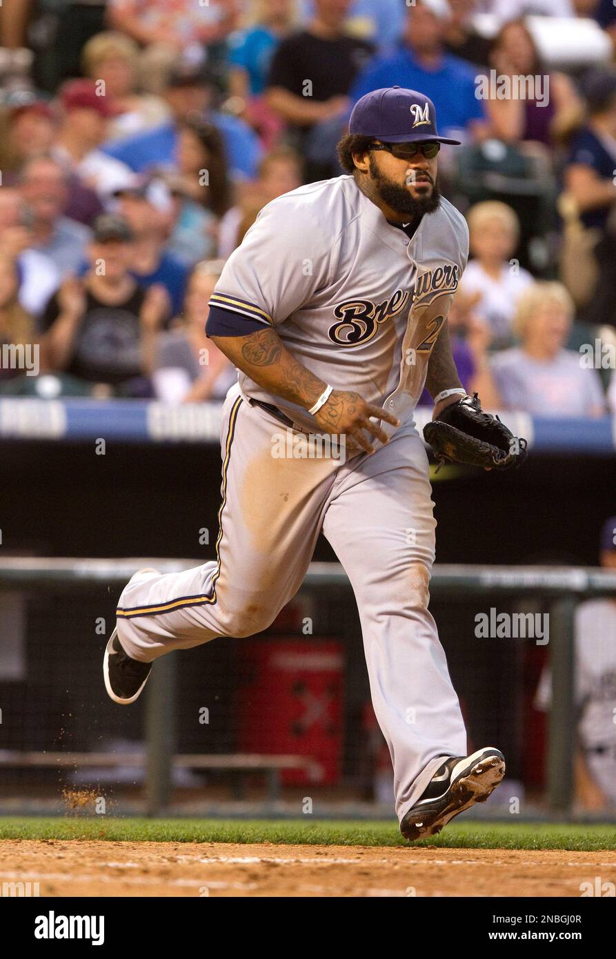 Milwaukee Brewers' Prince Fielder (28) heads onto the field after stopping  play to borrow a pair of sunglasses made by Oakley from a fan in the stands  during the fourth inning of