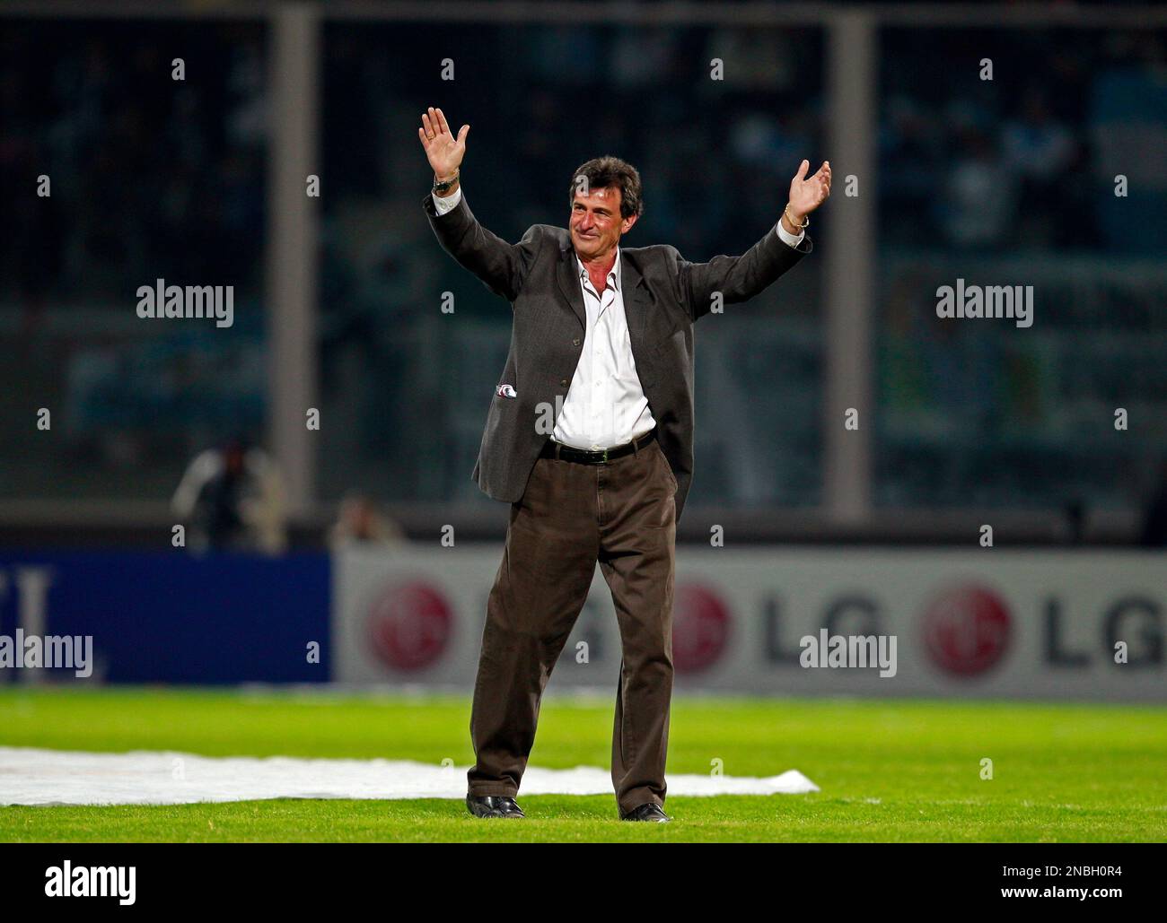 Argentina's former soccer player Mario Alberto Kempes waves to fans ...