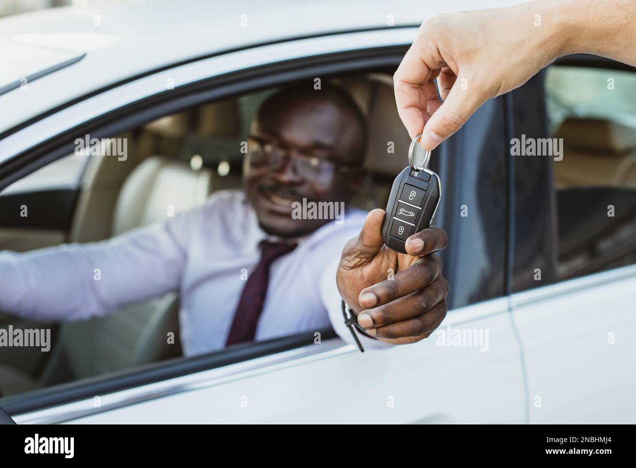 The concept of buying or renting a car. Closeup of handing over the