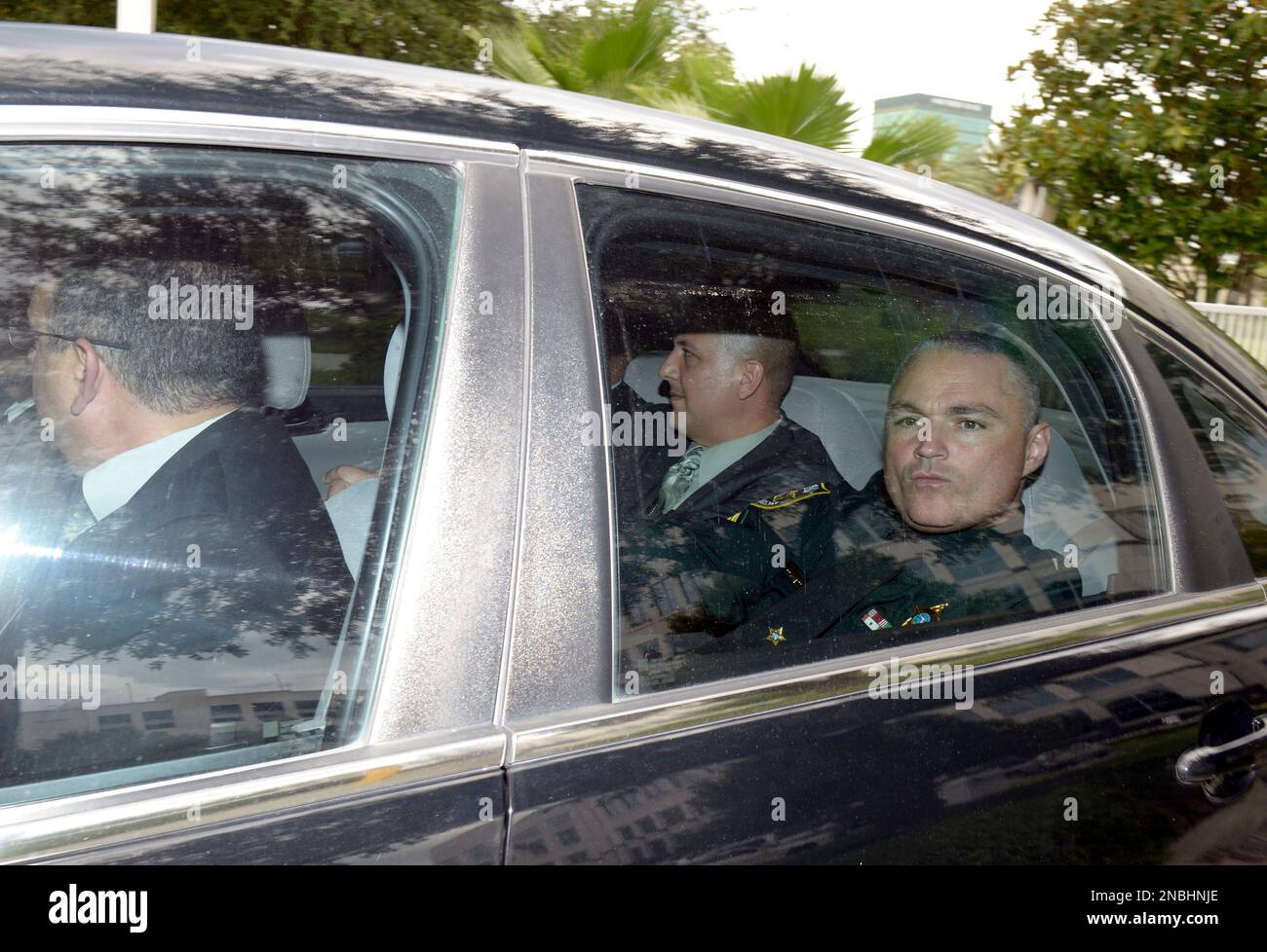 Casey Anthony investigators Yuri Melich, center, and Eric Edwards, right,  leave the Orange County Courthouse under police escort after the  announcement of the verdict in the Casey Anthony trial in Orlando, Fla.,