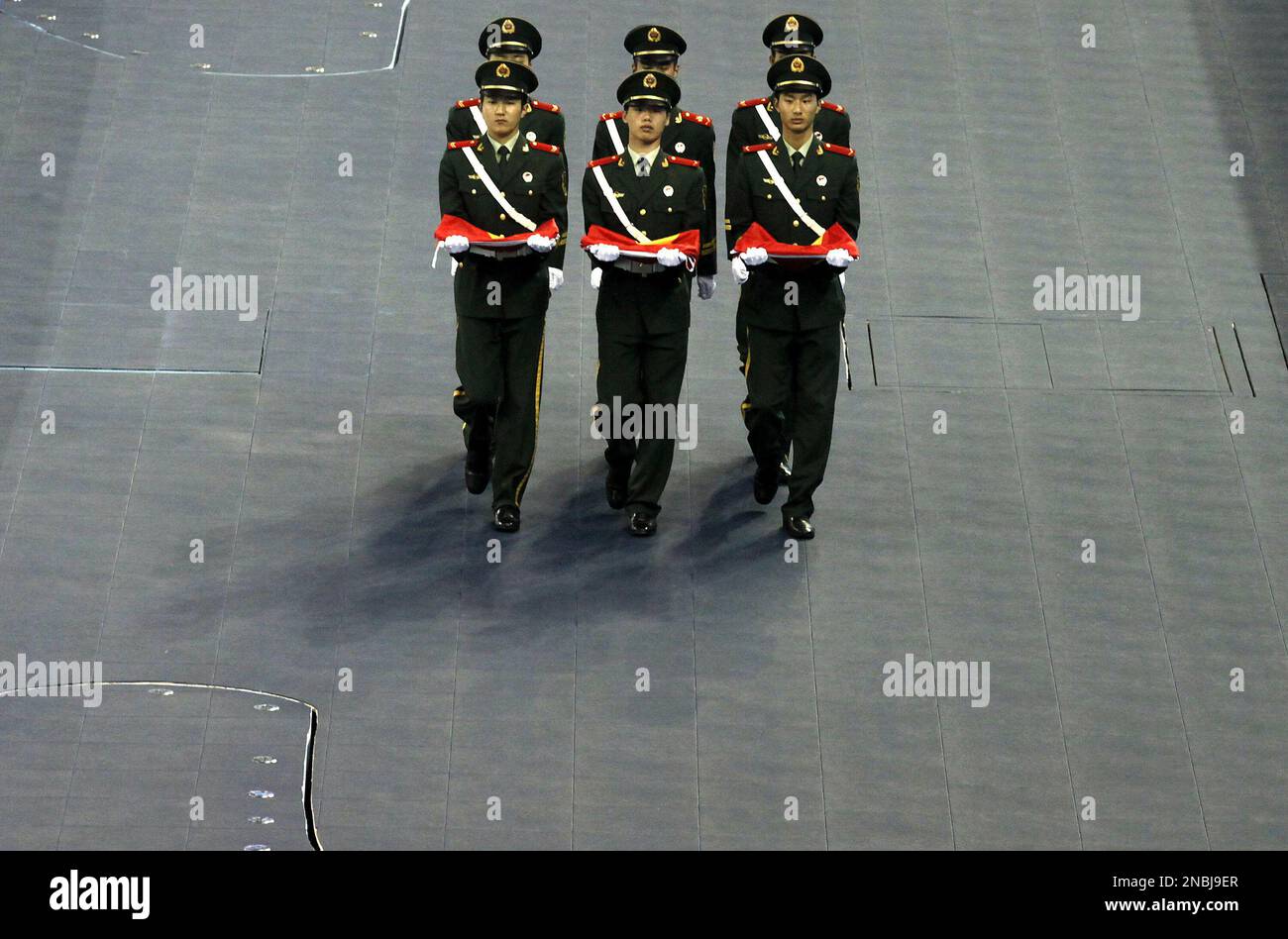 Chinese paramilitary police officers march to hoist Chinese flags