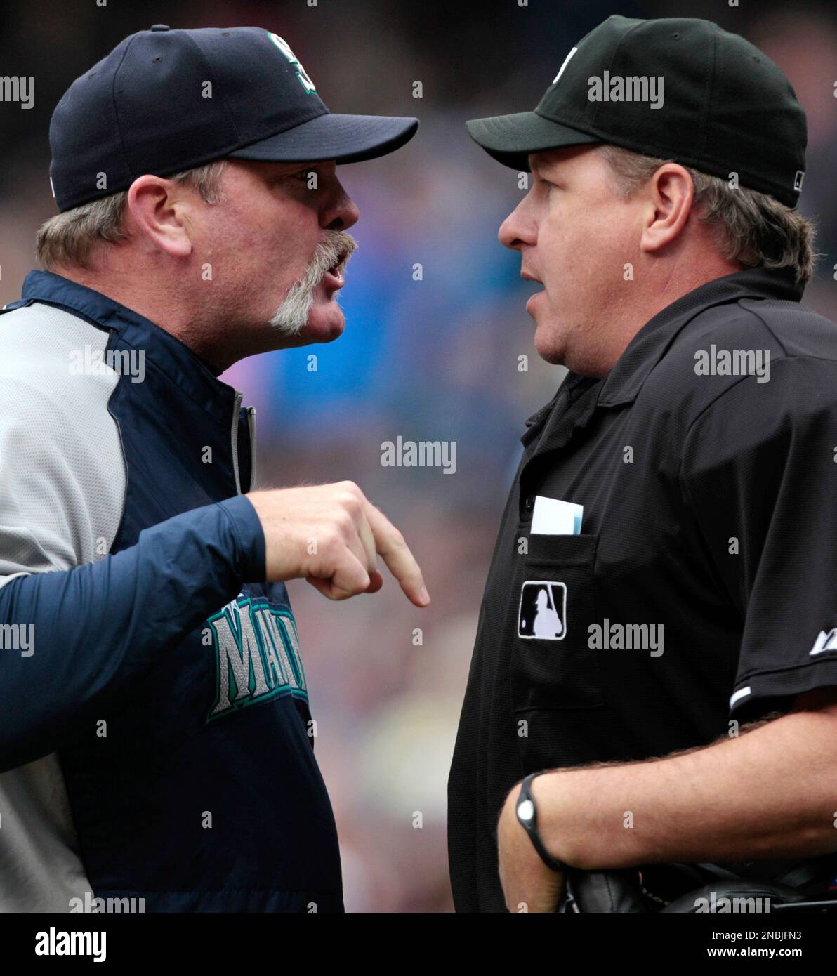 Seattle Mariners manager Eric Wedge, left, argues with plate umpire