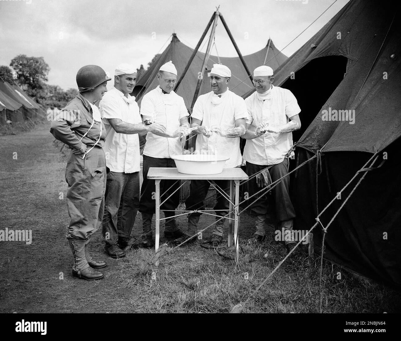 These U.S. medical corp doctors scrub up in an improvised basin before