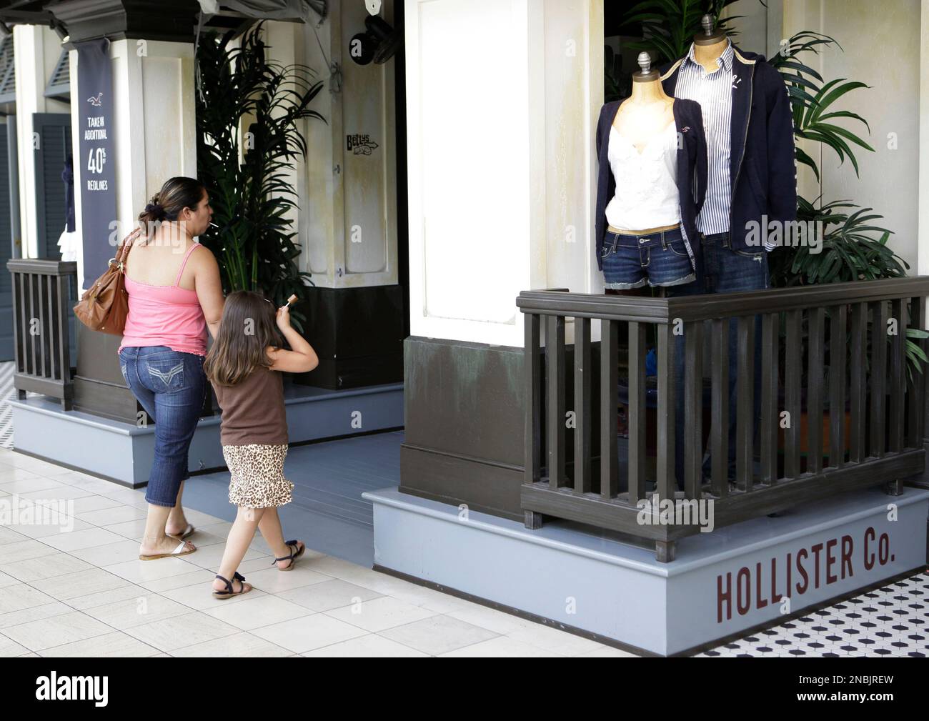 Customers enter a Hollister Co. store which is owned by Abercrombie Fitch Co. in San Mateo Calif. Monday June 27 2011. A former stockroom worker for Abercrombie Fitch Co. sued