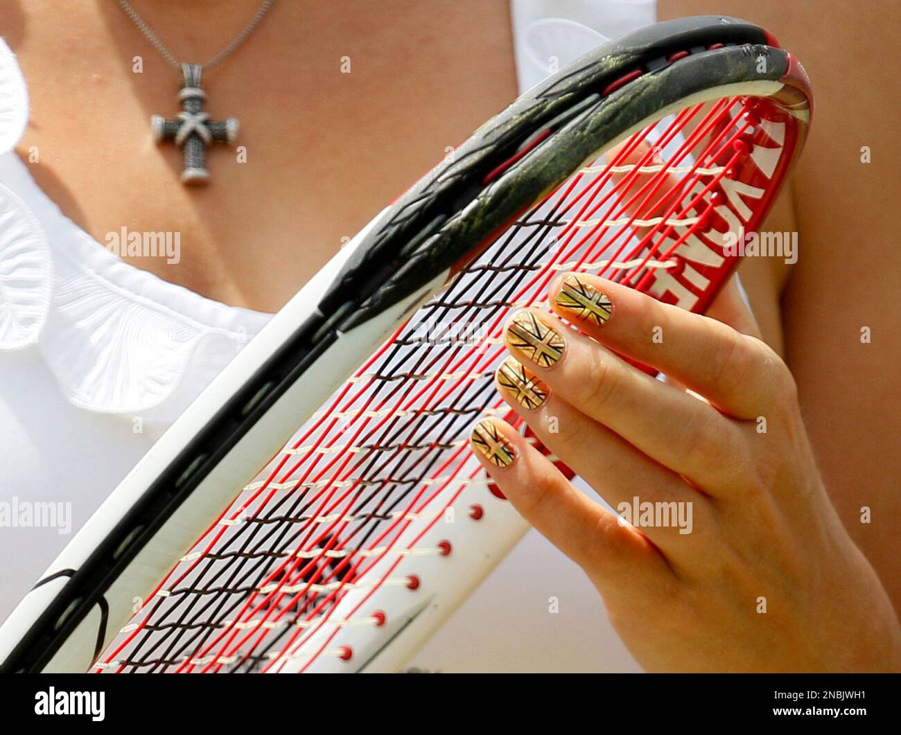 Denmark's Caroline Wozniacki touches the strings of her racquet during