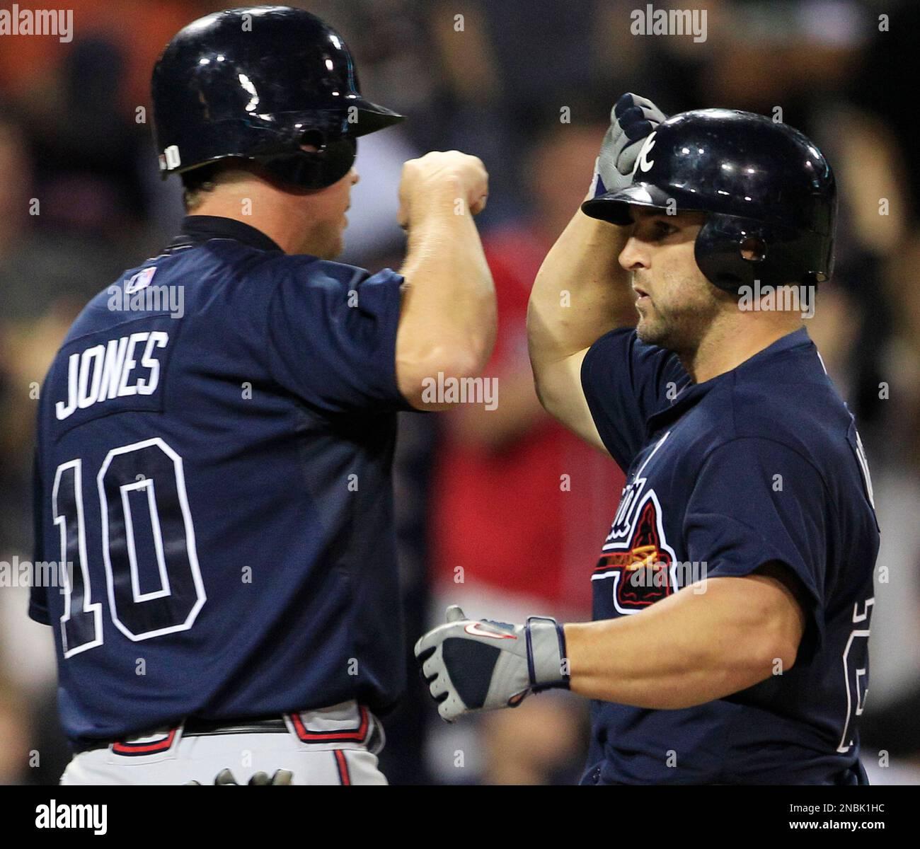 Atlanta Braves' Dan Uggla, right, bangs forearms with Chipper Jones after  Uggla's three-run home run against the San Diego Padres in the ninth inning  of the Braves' 10-1 victory in a baseball