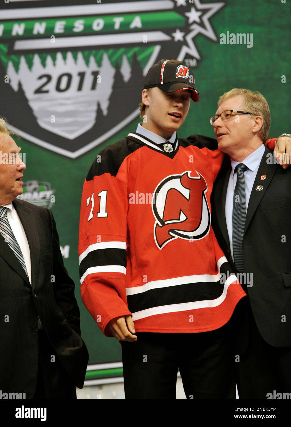 Adam Larsson poses with team officials after he was drafted in the first round by the New Jersey Devils in the National Hockey League entry draft Friday June 24 2011 in St