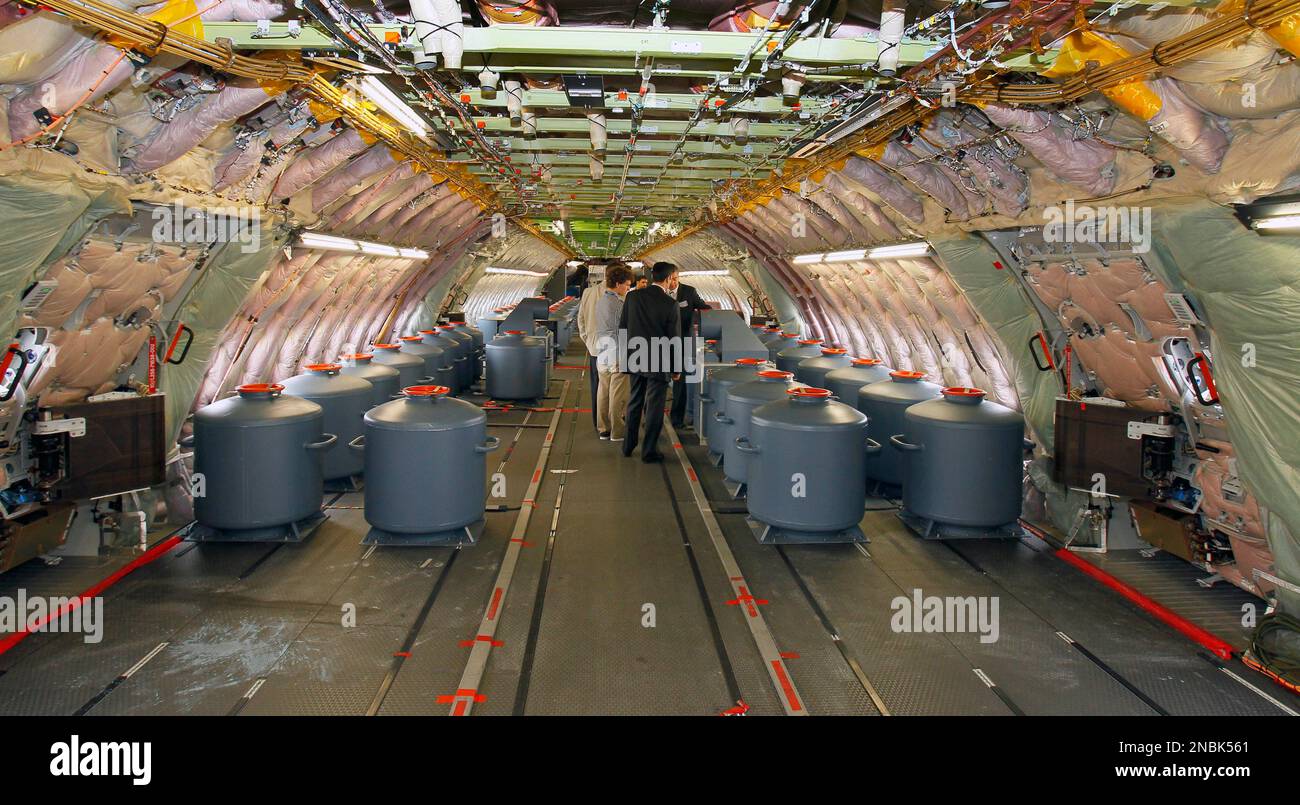 Visitors walk among the ballast's water tanks of the Airbus A380 during