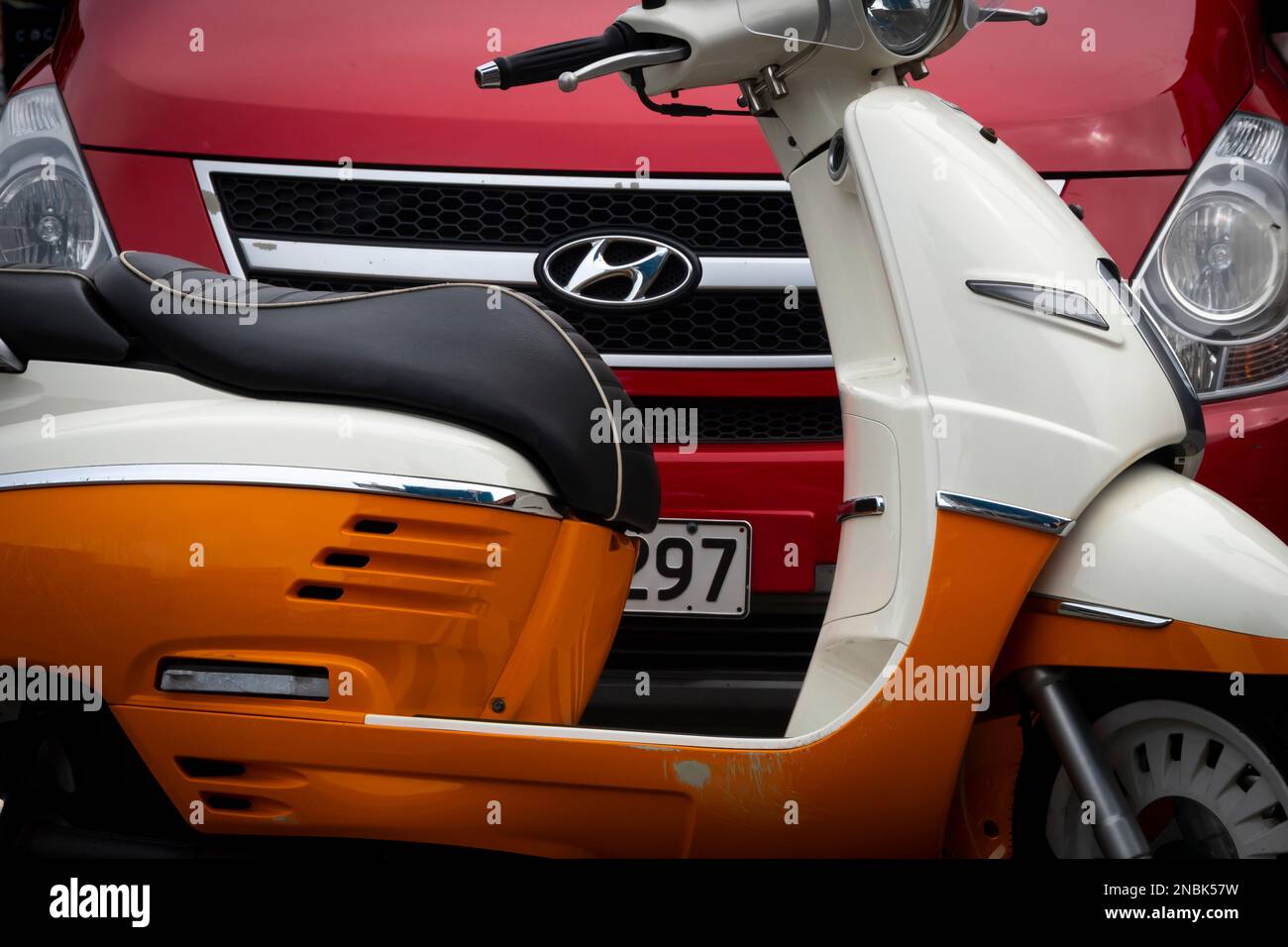 Scooter and car parked in street, Wellington, North Island, New Zealand