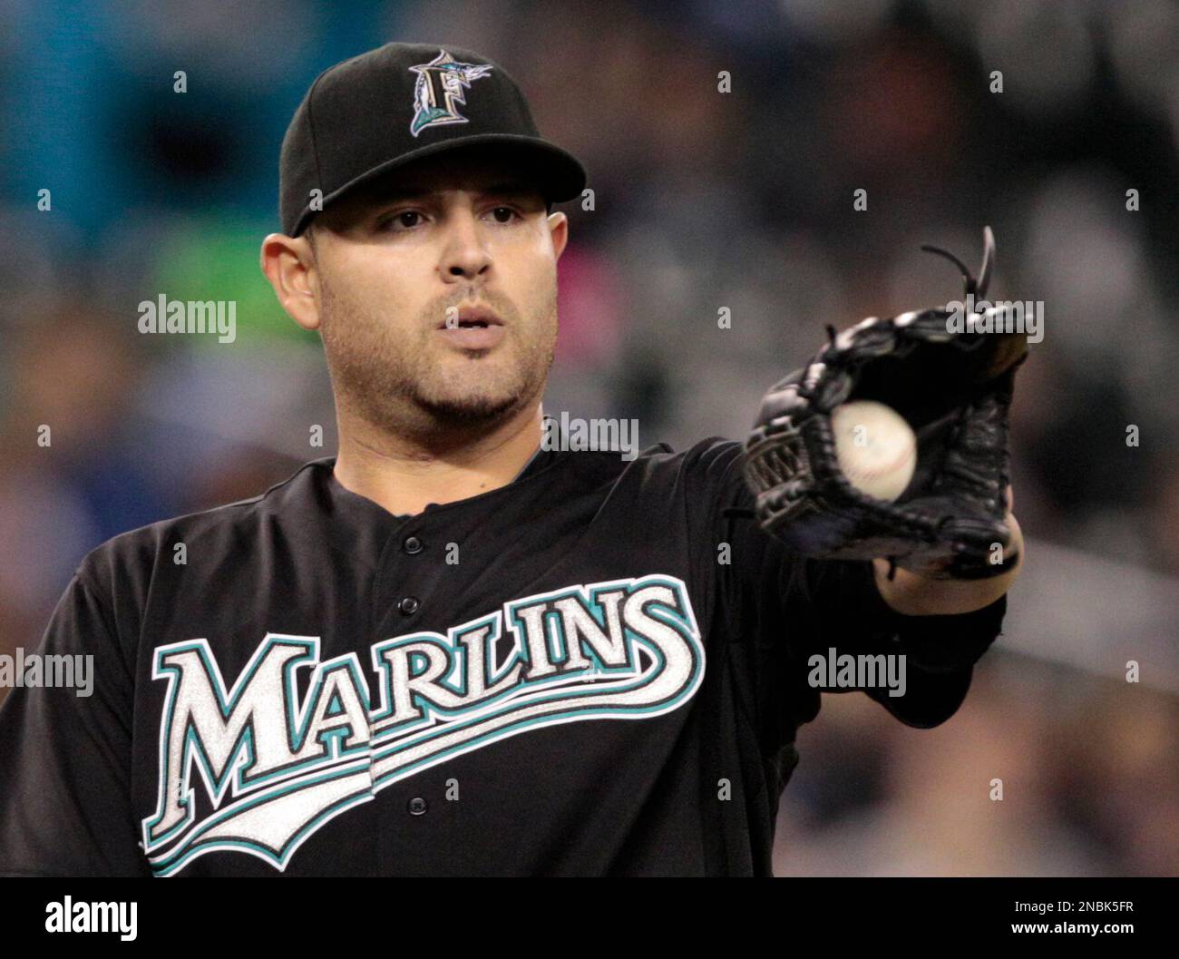 Florida Marlins starting pitcher Ricky Nolasco gets the ball back after giving up a hit to the