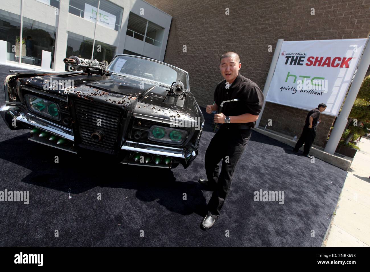 A guest poses in front of Sony's "Black Beauty," from the movie "The