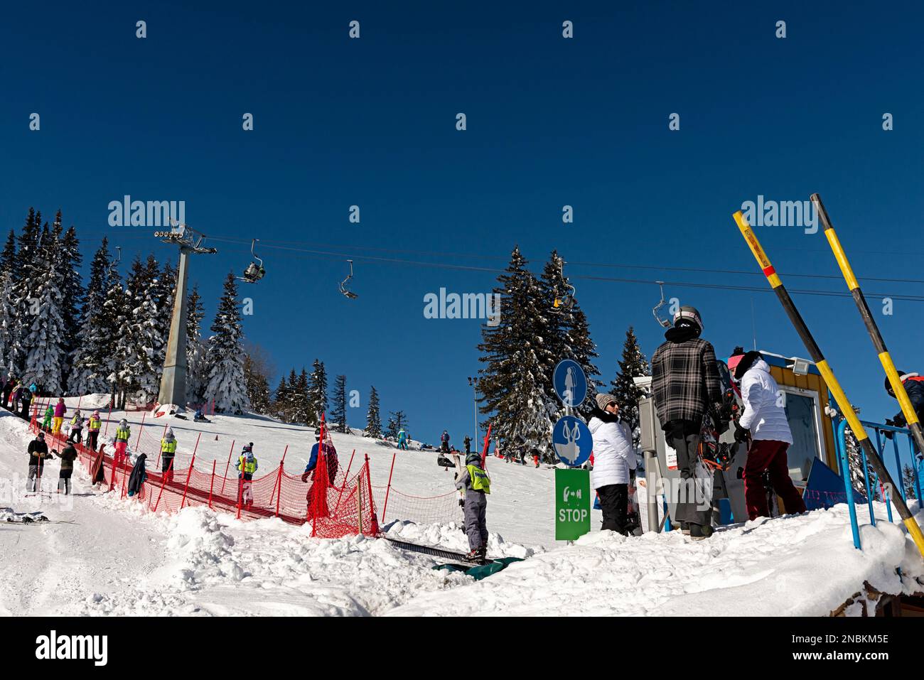 Skiers on moving carpet at a beginners ski slope in Vitosha Mountain