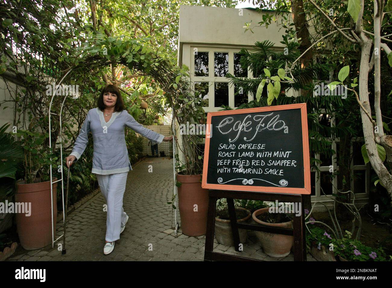 owner-of-cafe-flo-florence-villiers-walks-toward-the-entrance-of-her
