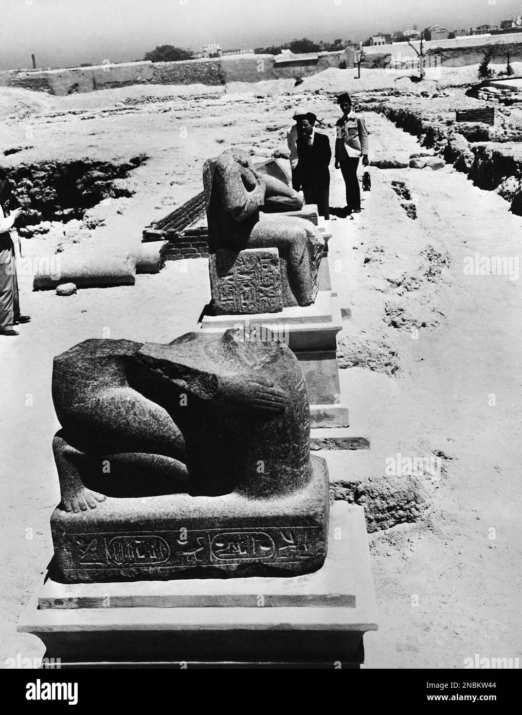 The broken statue of Rameses II and behind it a figure of the same king