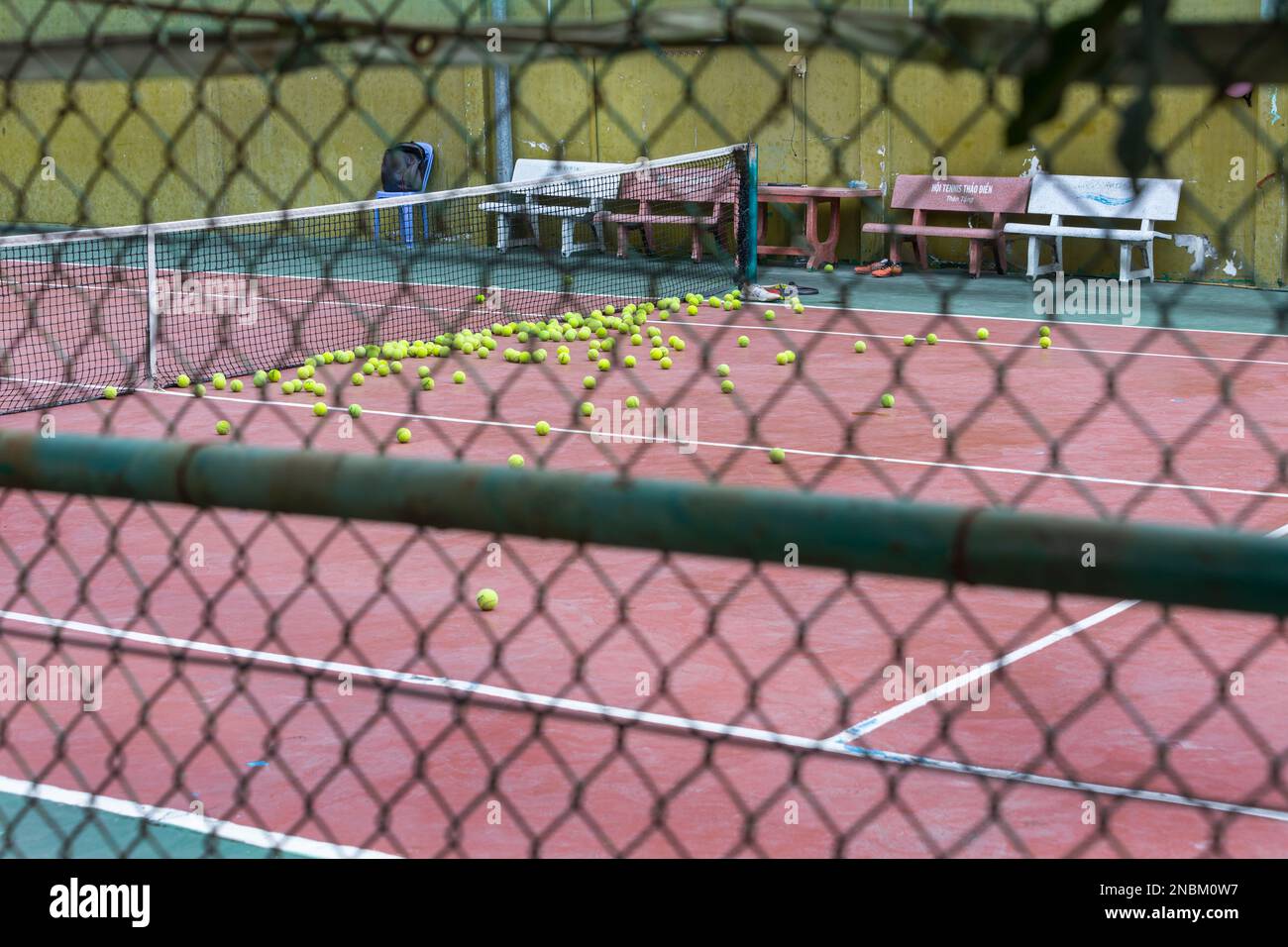 Tennis balls on a court in Thao Dien, District 2 in Ho Chi Minh City after a practice session Stock Photo