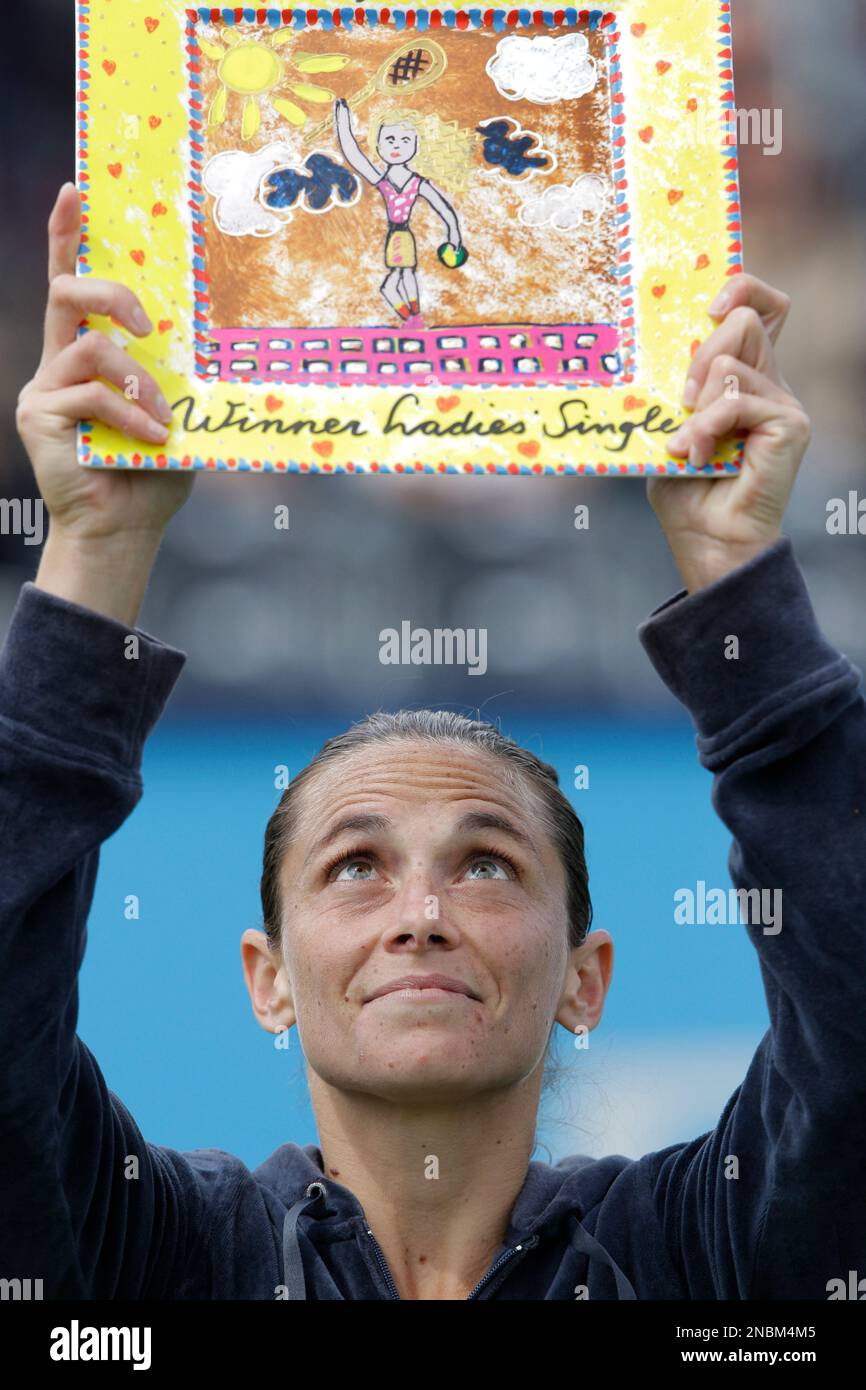 Roberta Vinci of Italy holds the trophy as she celebrates defeating Jelena Dokic of Australia in three sets, 6-7, 6-3, 7-5, in the women's final of the Unicef Open tennis tournament in Den Bosch, central Netherlands Saturday June 18, 2011. (AP Photo/Peter Dejong) Stock Photo
