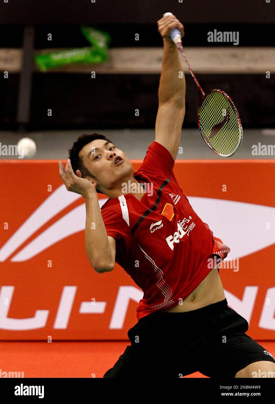 Lin Dan of China returns a shot to Peter Gade of Denmark during the Li