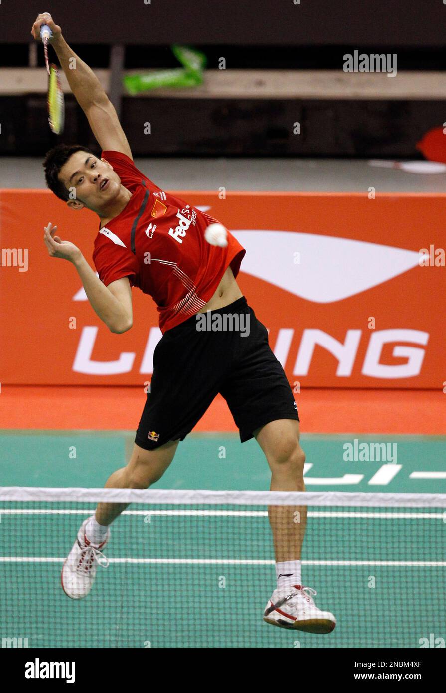 Lin Dan of China returns a shot to Peter Gade of Denmark during the Li