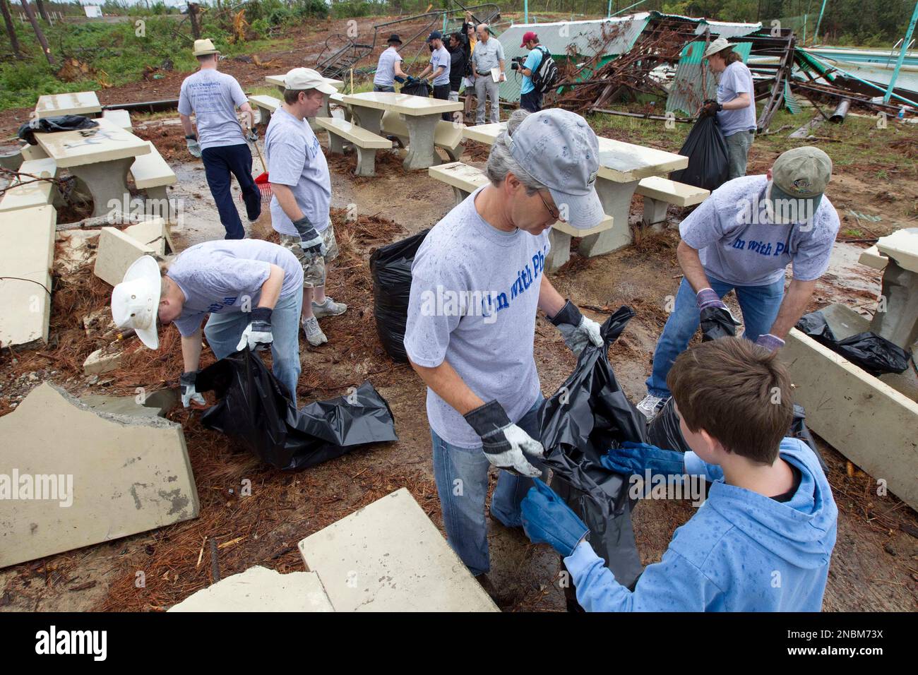 A group of men named Phil Campbell help clean up tornado debris in in