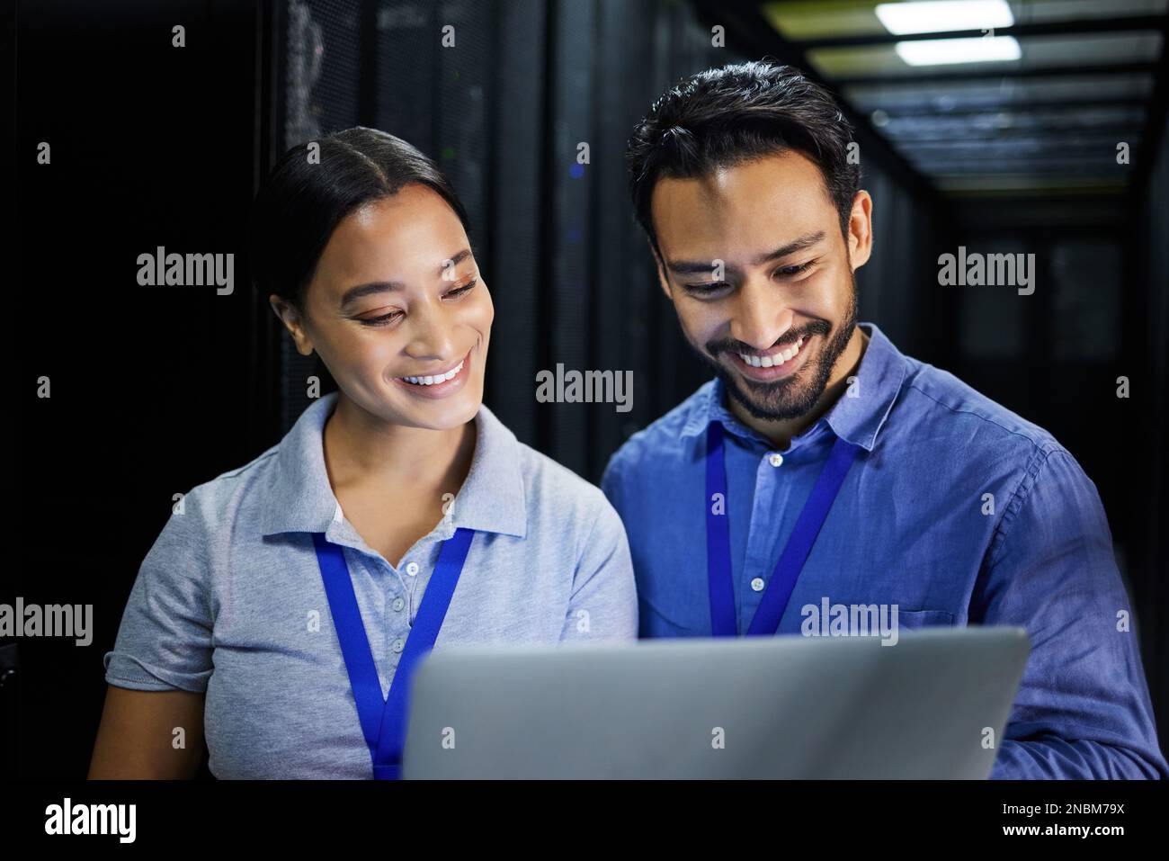 People, happy or laptop in server room, IT engineering or software programming for cybersecurity, analytics or database safety. Smile, man or data Stock Photo