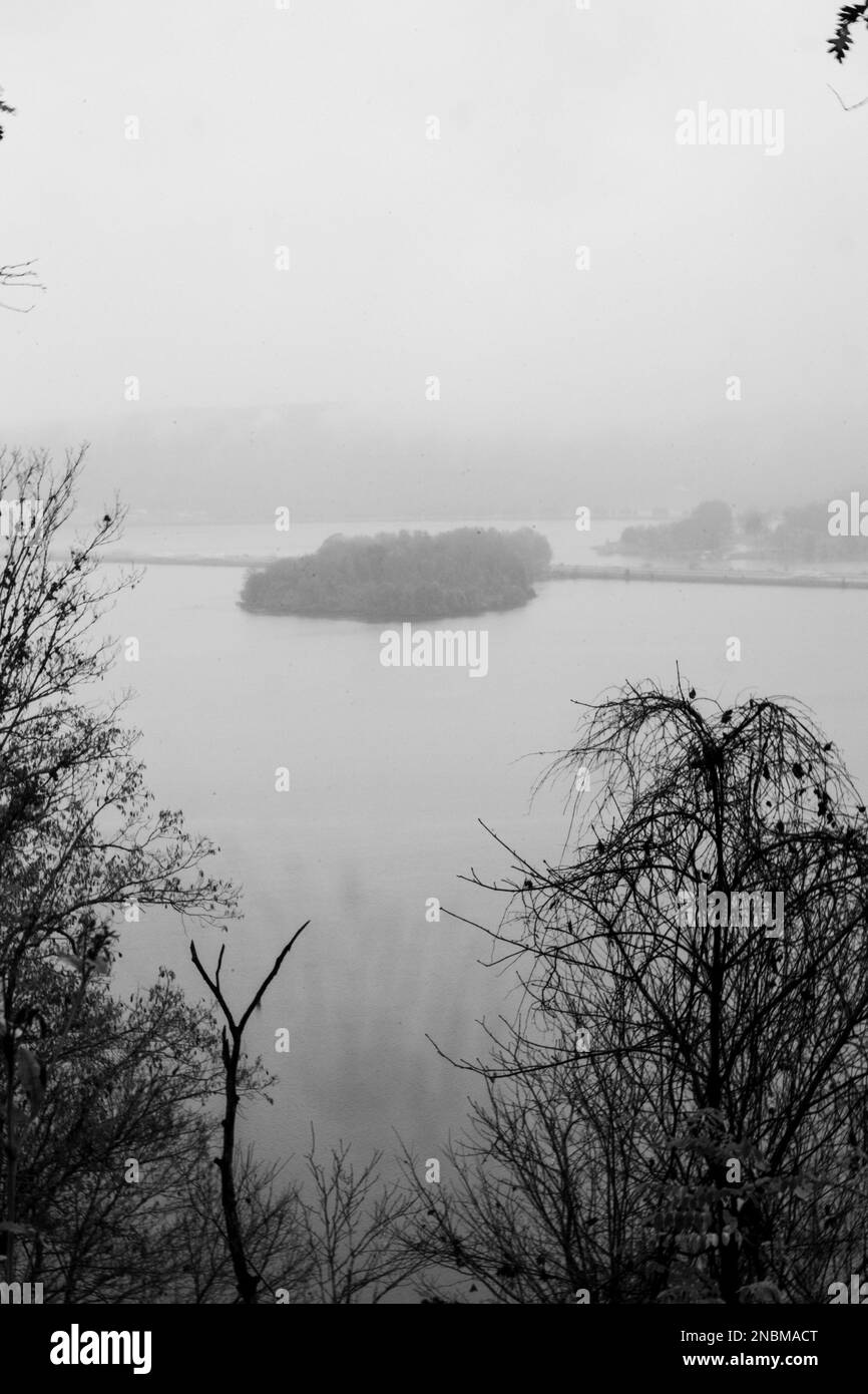 An aerial view of lake surrounded by trees in foggy day Stock Photo - Alamy