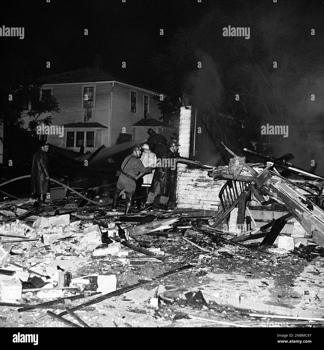 Omaha firemen fight the fire that followed an explosion that wrecked a ...