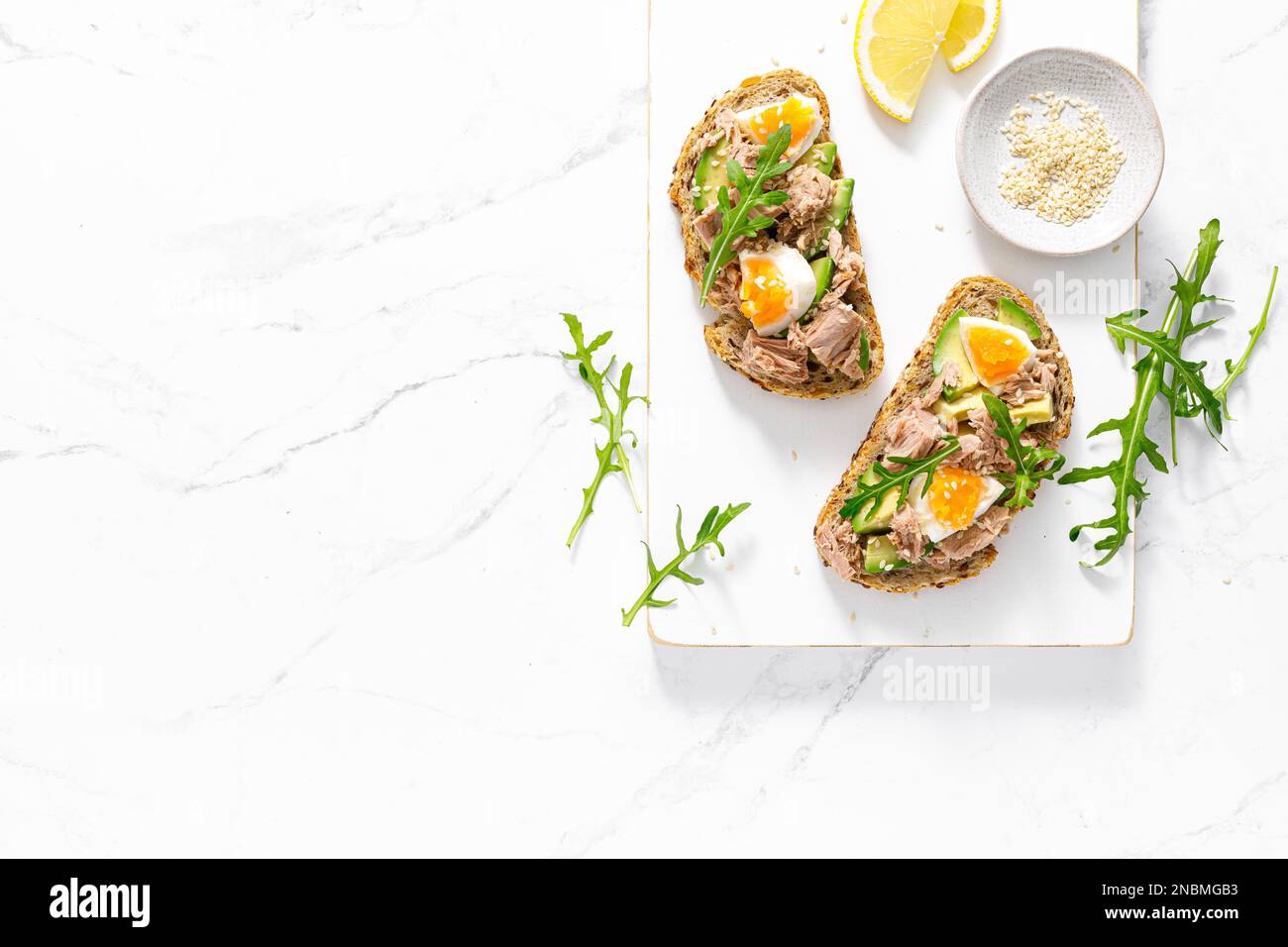 Tuna toast. Open sandwiches with whole grain bread, canned tuna, boiled