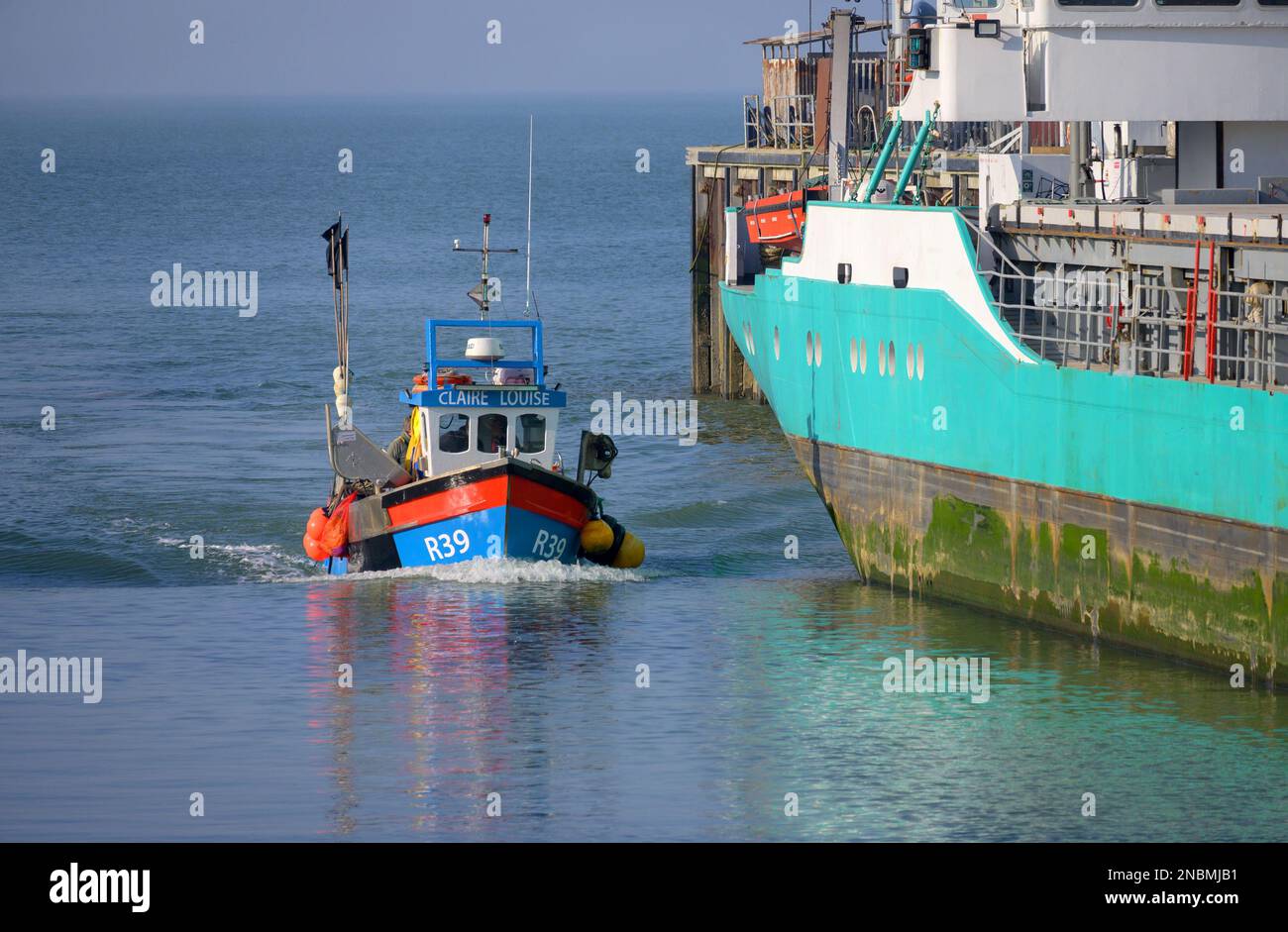Whitstable, Kent, England, UK. Small fishing boat entering the harbour ...