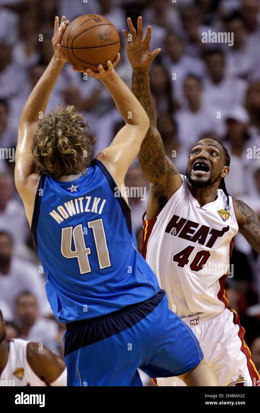 Dallas Mavericks' Dirk Nowitzki shoots with Miami Heat's Udonis Haslem  defending during the second half of Game 6 of the NBA Finals basketball  game Sunday, June 12, 2011, in Miami. (AP Photo/David