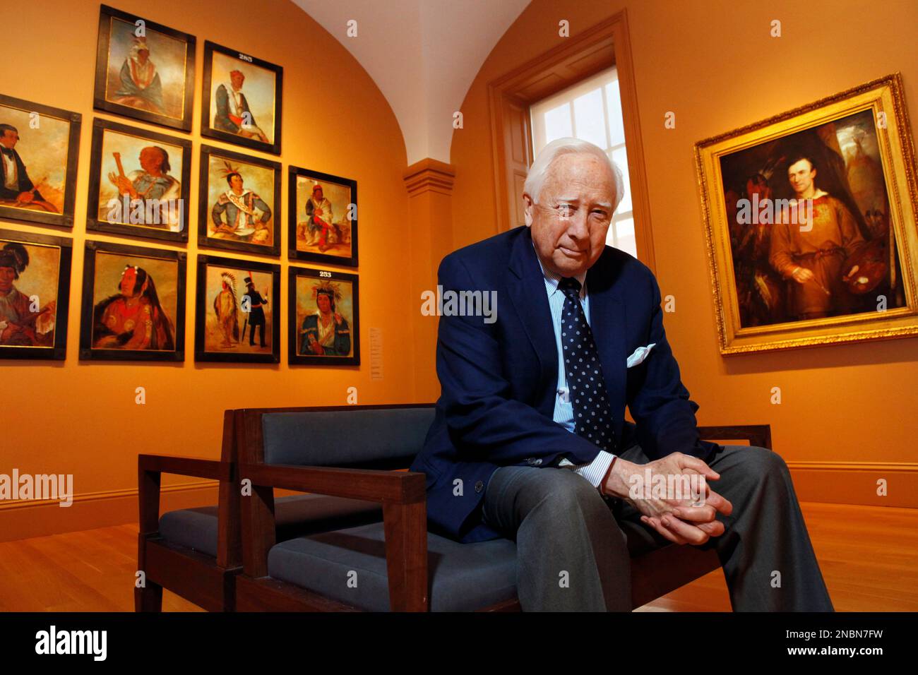 In this May 13, 2011 photo, historian and author David McCullough poses with art by George Catlin, one of the artists featured in his new book, "The Greater Journey," at the Catlin galleries of the Smithsonian American Art Museum in Washington. The book is about Americans in Paris in the 19th century. At left are Catlin's paintings, at right is a painting of Caltin by William Fisk. (AP Photo/Jacquelyn Martin) Stock Photo