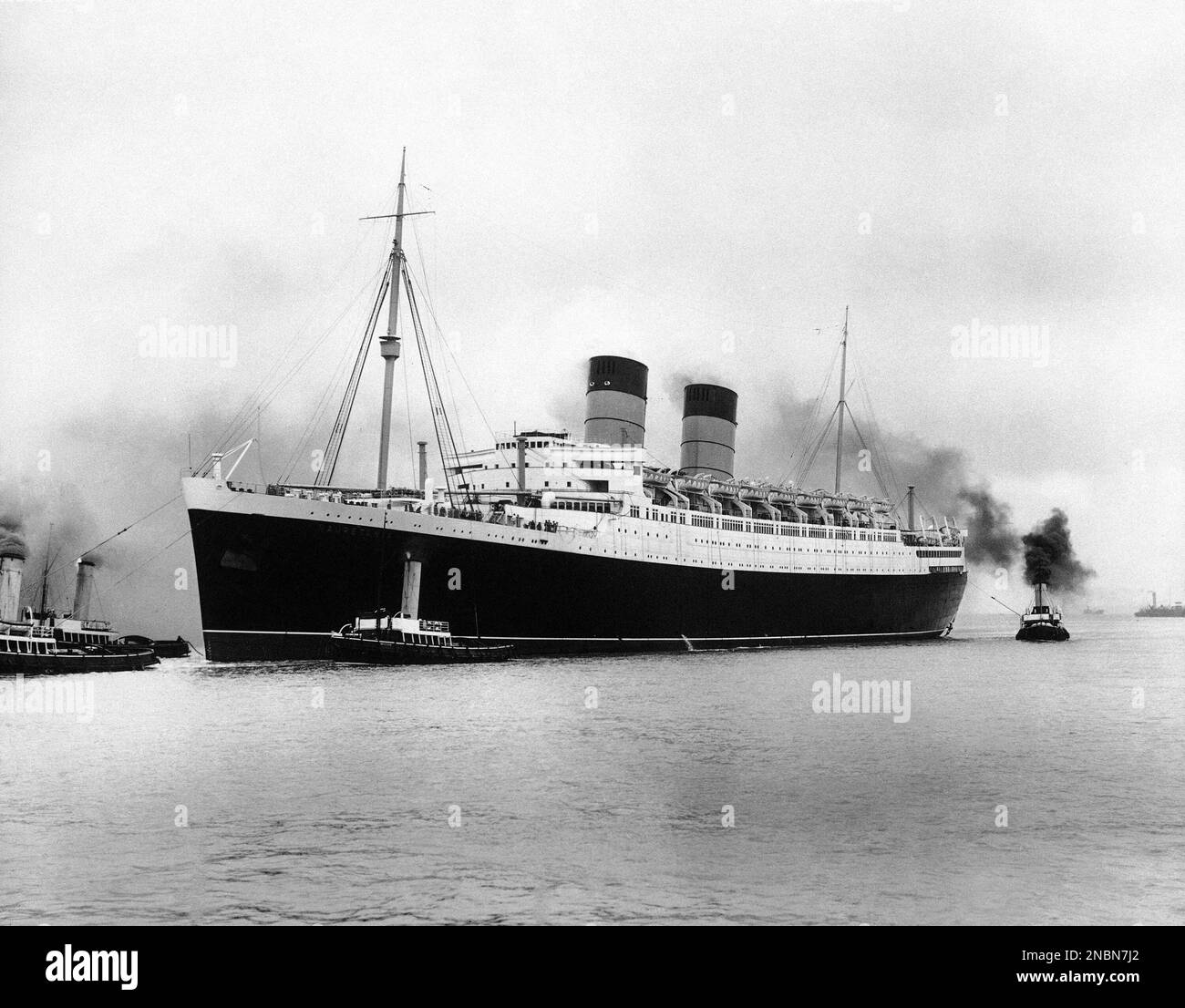The liner S.S. Mauretania being towed into harbour, in England, on June ...