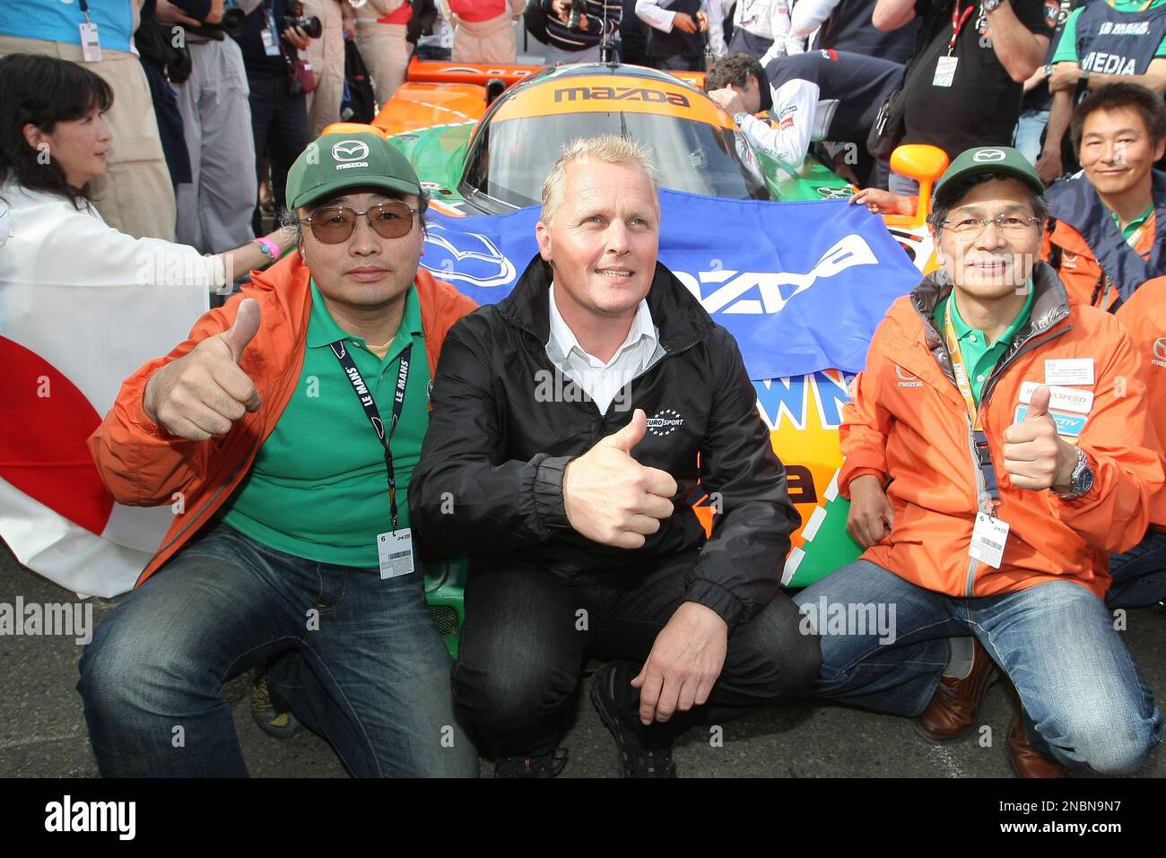 British driver Johnny Herbert, center, pose for photographs in front of