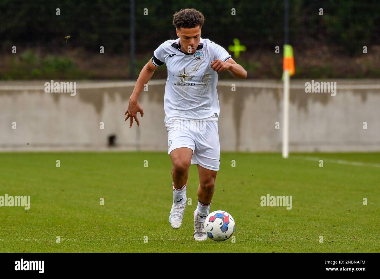 Swansea, Wales. 4 February 2023. Zane Myers of Swansea City under pressure  from Oliver Evans of Millwall during the Professional Development League  game between Swansea City Under 18 and Millwall Under 18