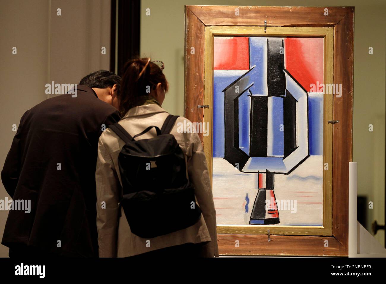 Visitors look at a double-sided painting 'Sailor and Phantomas' by Czech  artist Josef Capek on display at Sotheby's auction house in London,  Thursday, June 9, 2011. The painting is to be auctioned