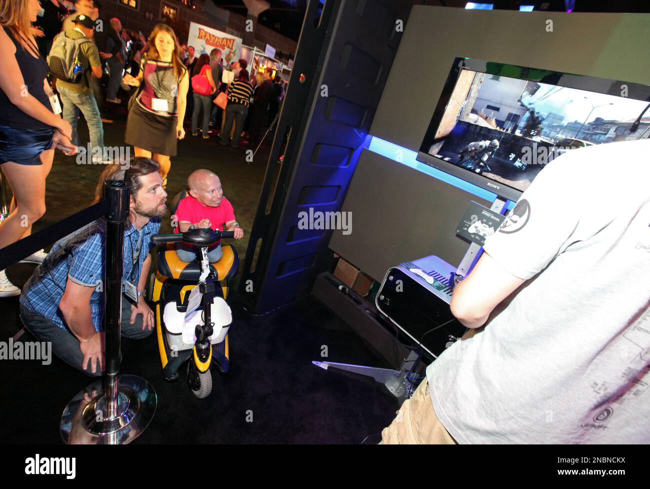 Ubisoft's Tommy Jacob and Verne Troyer watch a demonstration of Tom