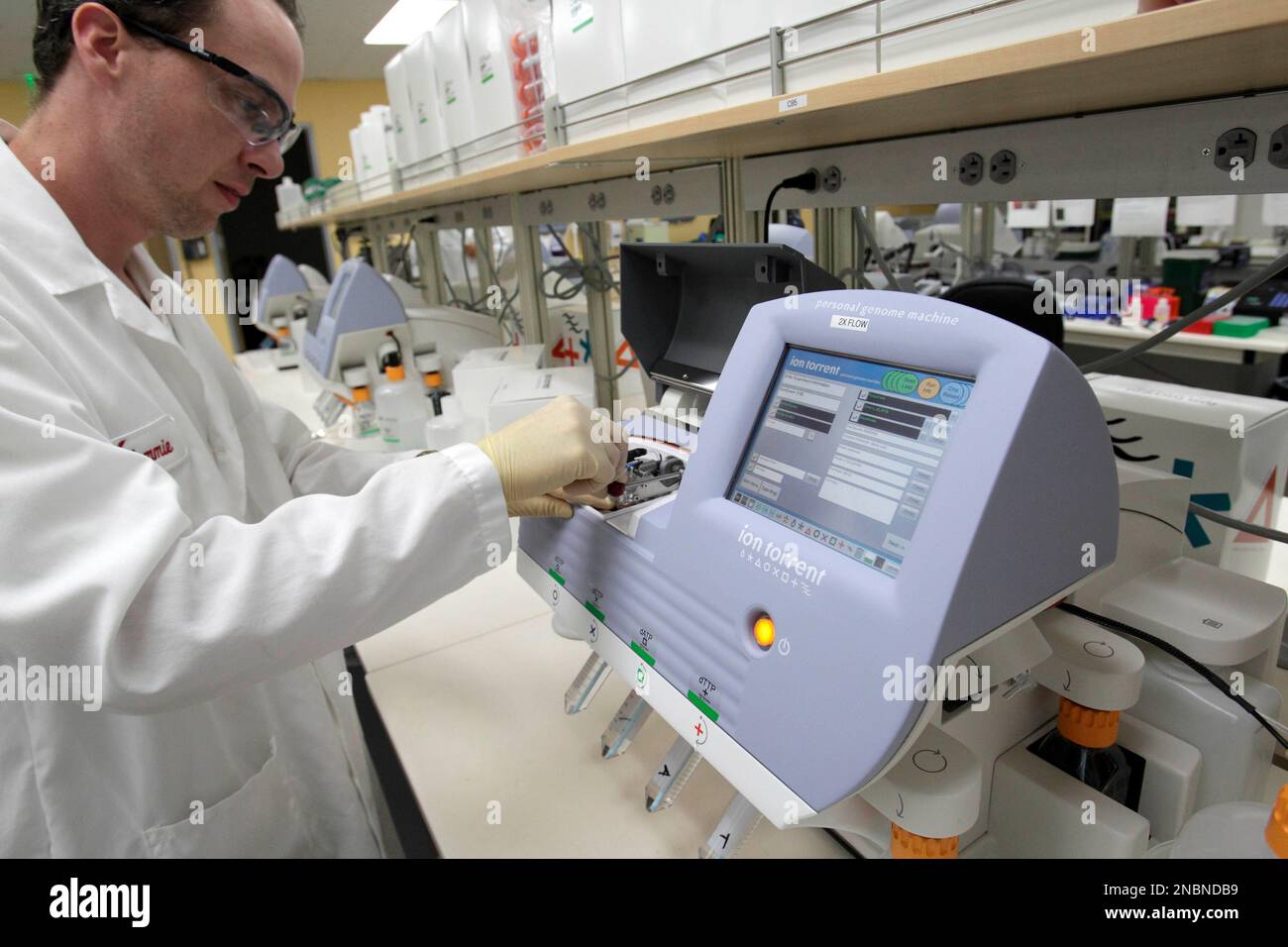 Scientist Tommie Lincecum Works With A Machine That Reads DNA And.