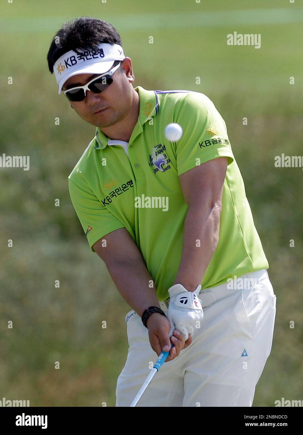 Y.E. Yang, of South Korea, chips onto the 13th green during the Pro-Am ...