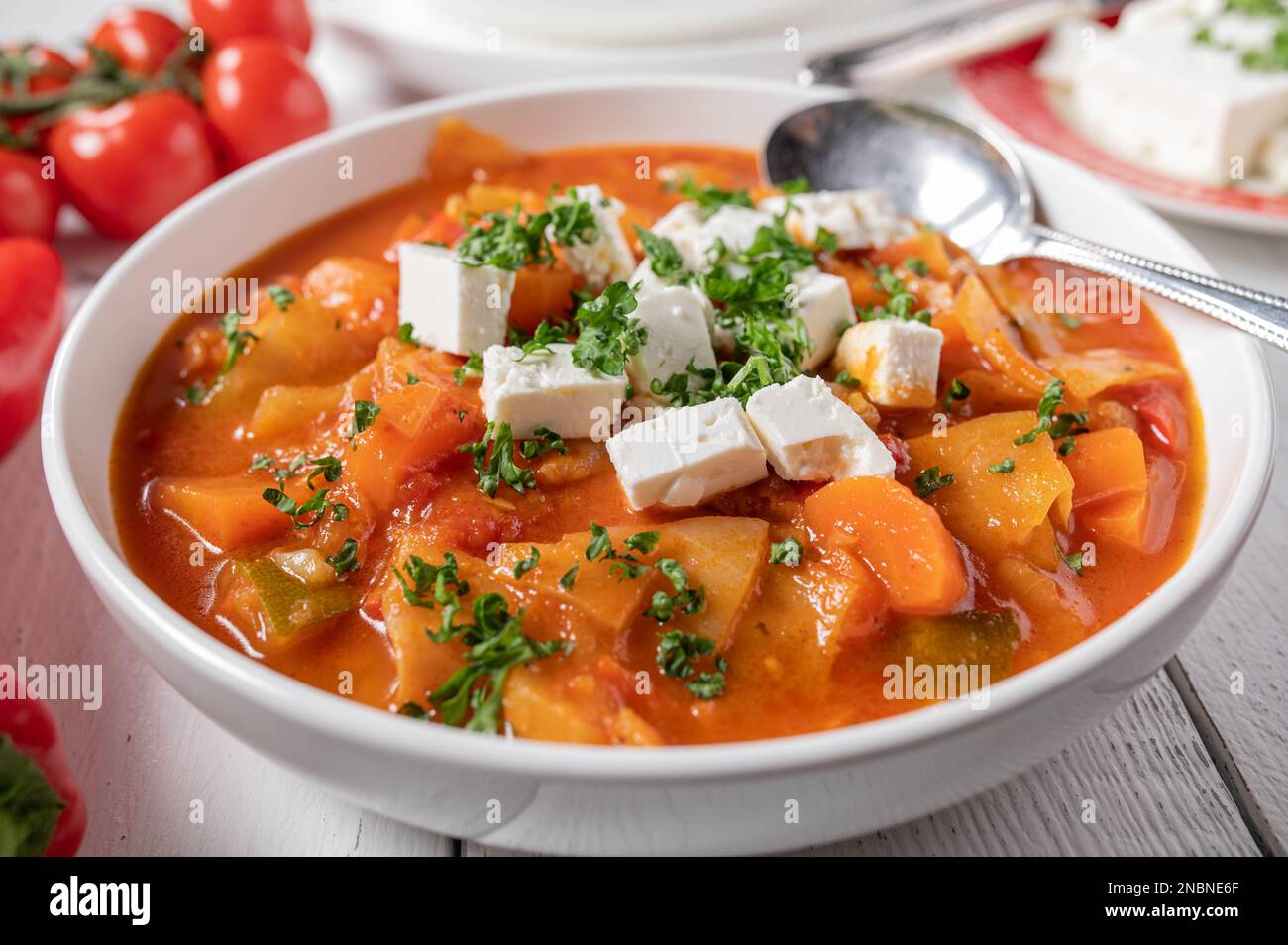 Vegetable soup with cabbage and feta cheese topping on a plate.Healthy detox meal Stock Photo