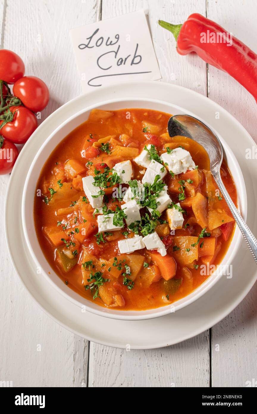 Low carb dinner or lunch with a fresh cooked cabbage, vegetable soup and feta cheese topping Stock Photo