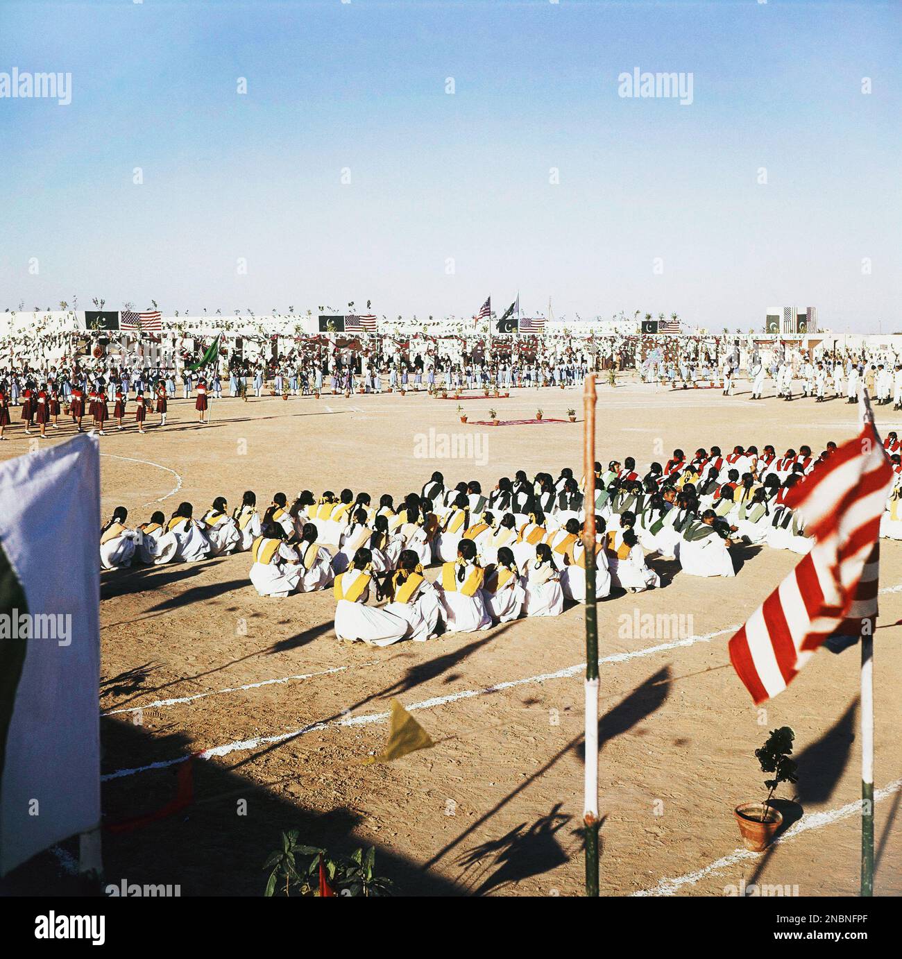 School children with flags and red uniforms are school band in Karachi