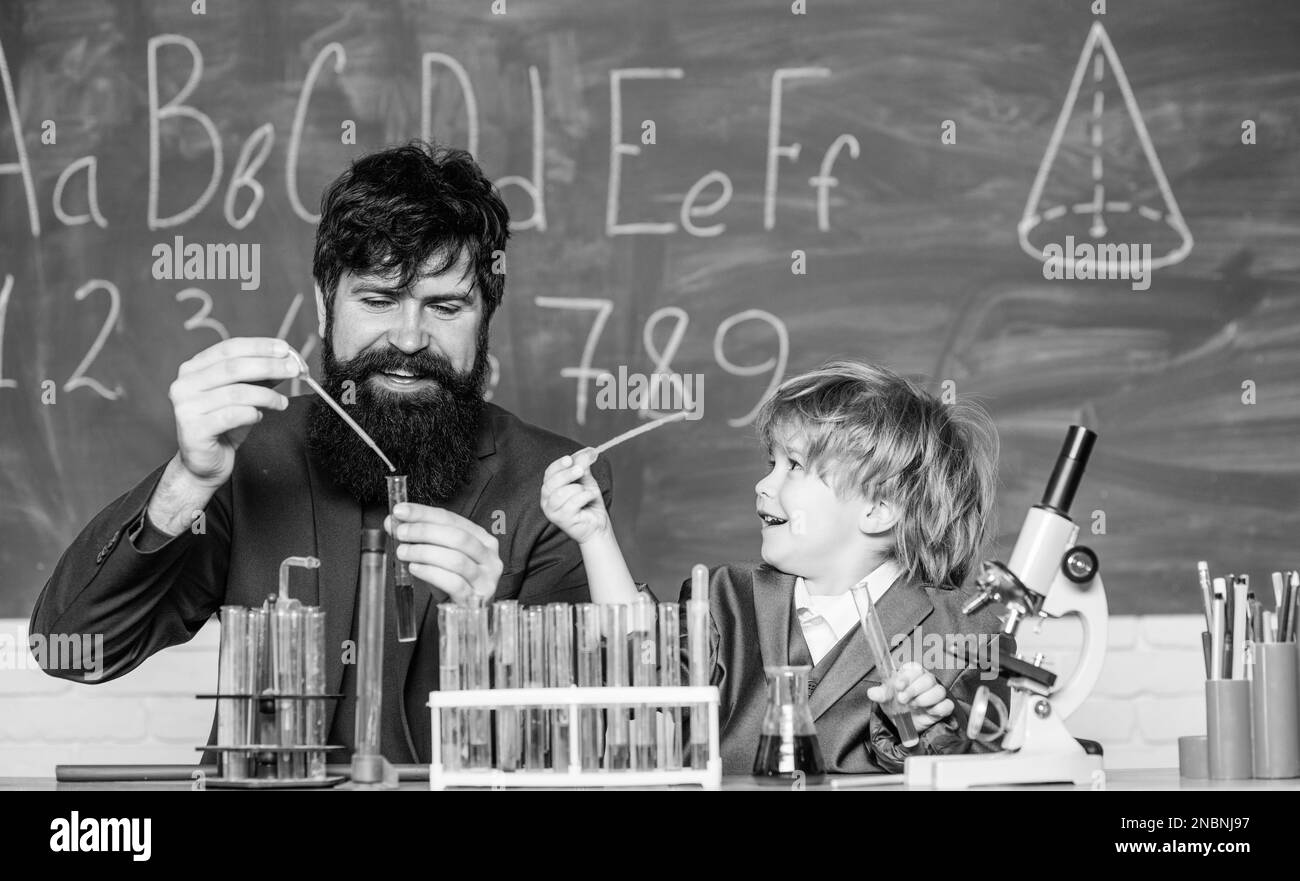 Chemistry is fun. learning chemistry in school laboratory. father and