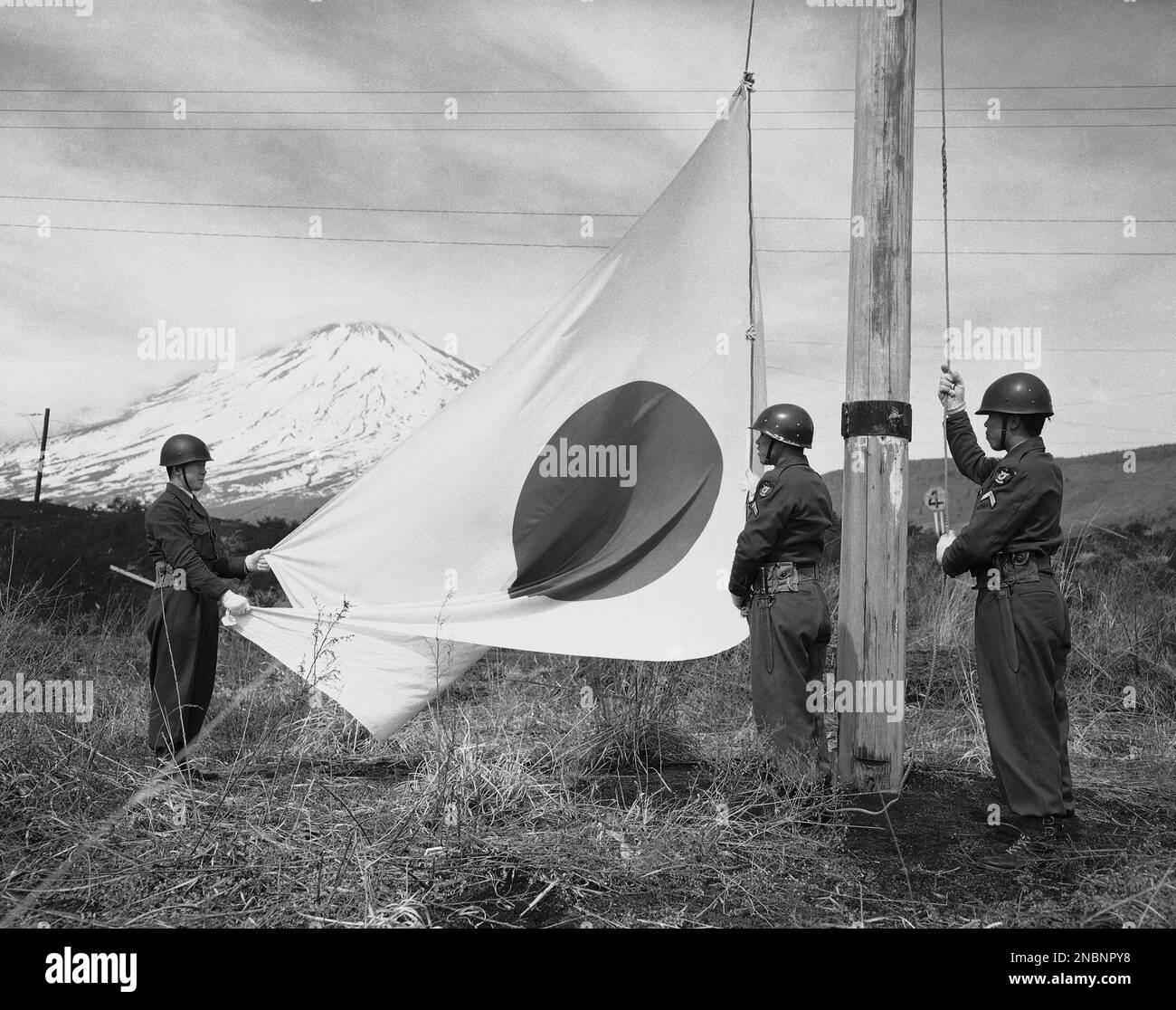 Snowcapped Mount Fuji forms a picturesque background as Japanese honor guard soldiers raise the