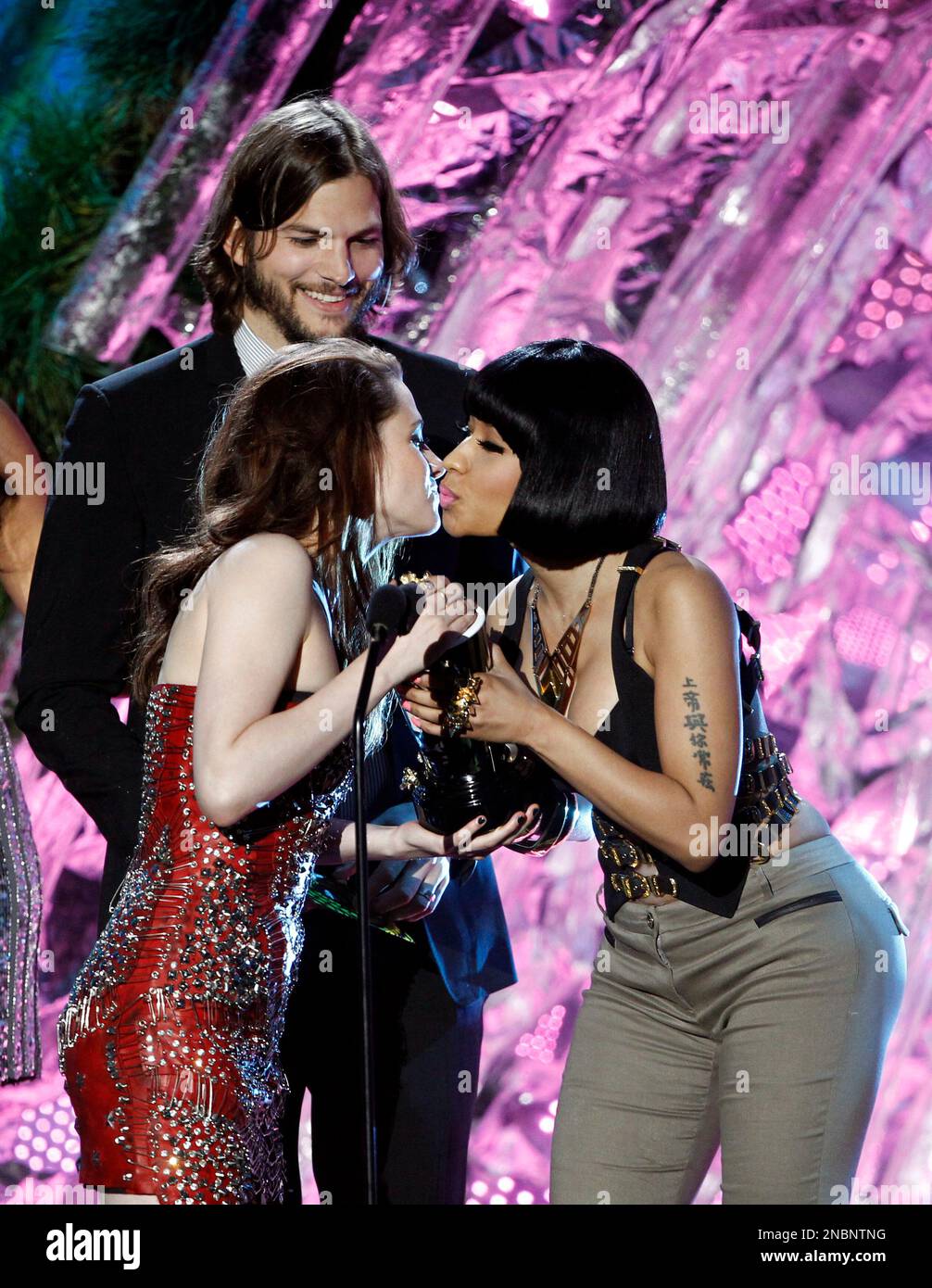 Kristen Stewart, left, accepts the award for best female performance from  presenter Nicki Minaj at the MTV Movie Awards on Sunday, June 5, 2011, in  Los Angeles. IN background is presenter Ashton