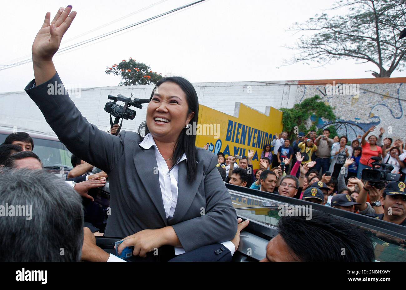 Presidential candidate Keiko Fujimori waves to supporters outside a